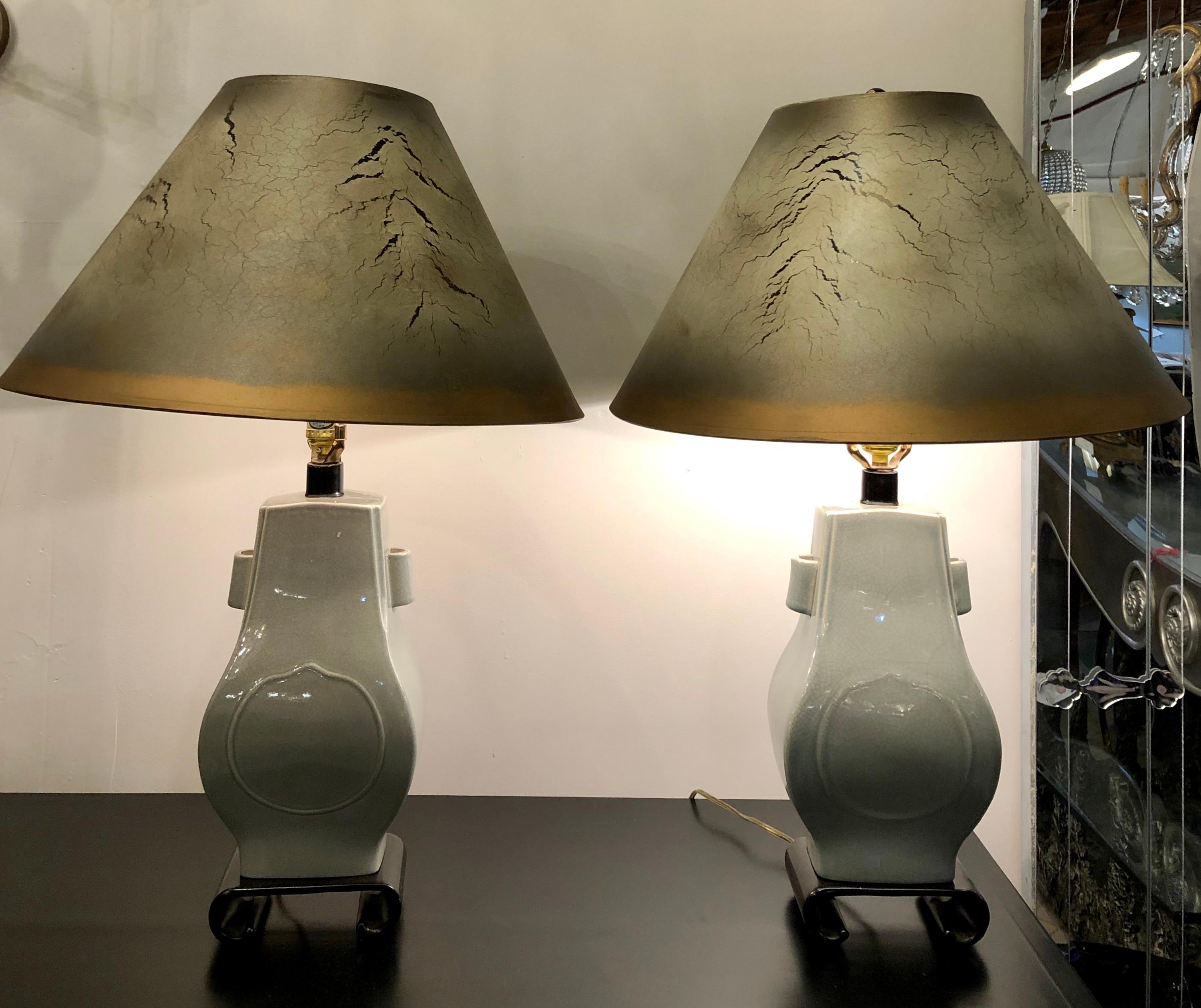 Porcelain crackle glaze table lamps. Chinese inspired pair of mint green table lamps each with a custom shade. The pair sitting on teak bases with matching crackle ware lamp shades.