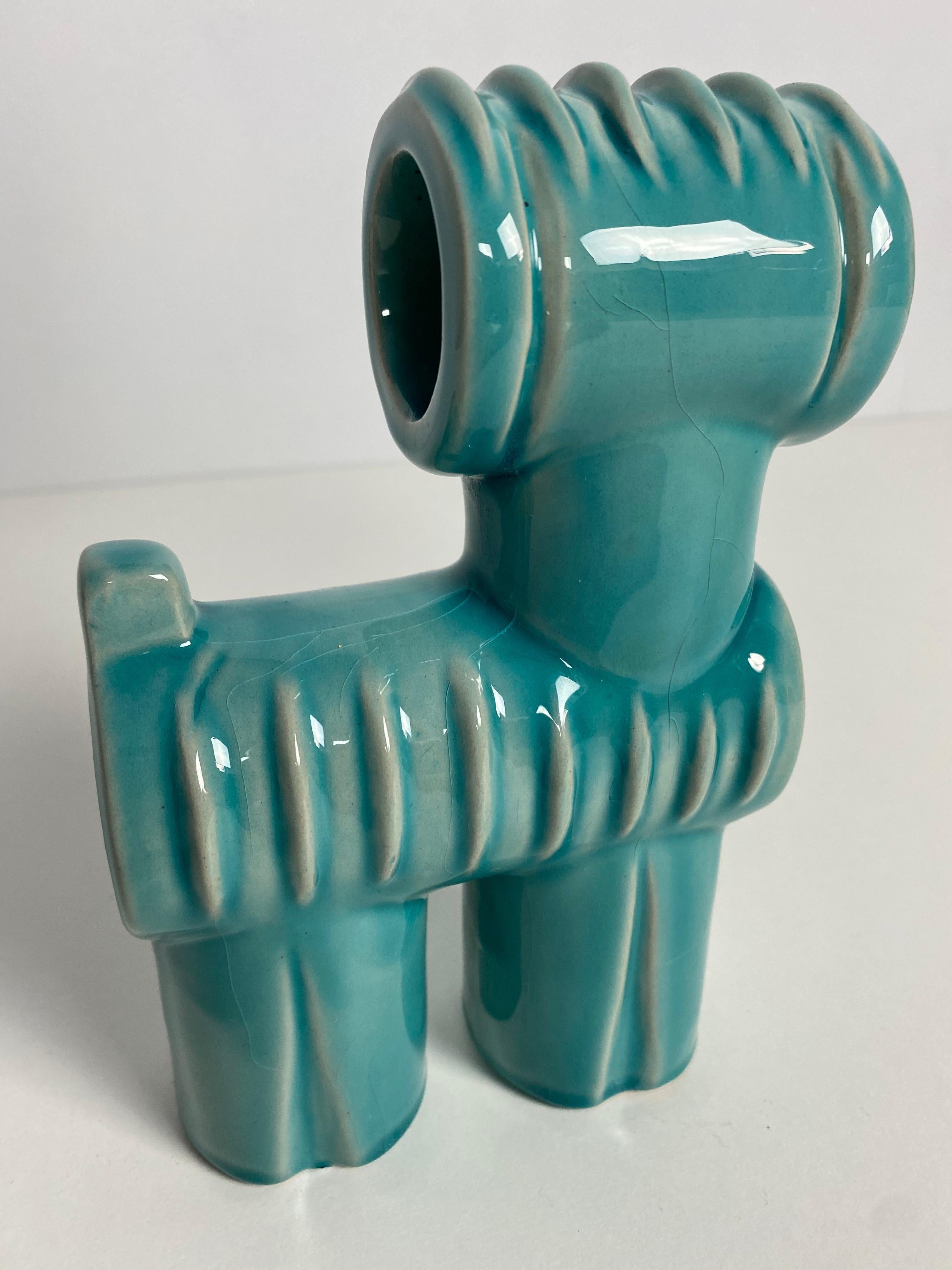 Porcelain cubist dog with a blue pre-eosin glaze by Judit Nádor of Pécs porcelain factory, Zsolnay.

Dimensions (cm, approx): 
Height: 18 
Width: 11 
Depth: 6

Good condition with cracks to the glaze (not the porcelain).