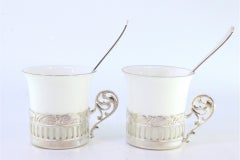 Porcelain cups with silver stands and two coffee spoons with their own case