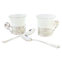Porcelain cups with silver stands and two coffee spoons with their own case