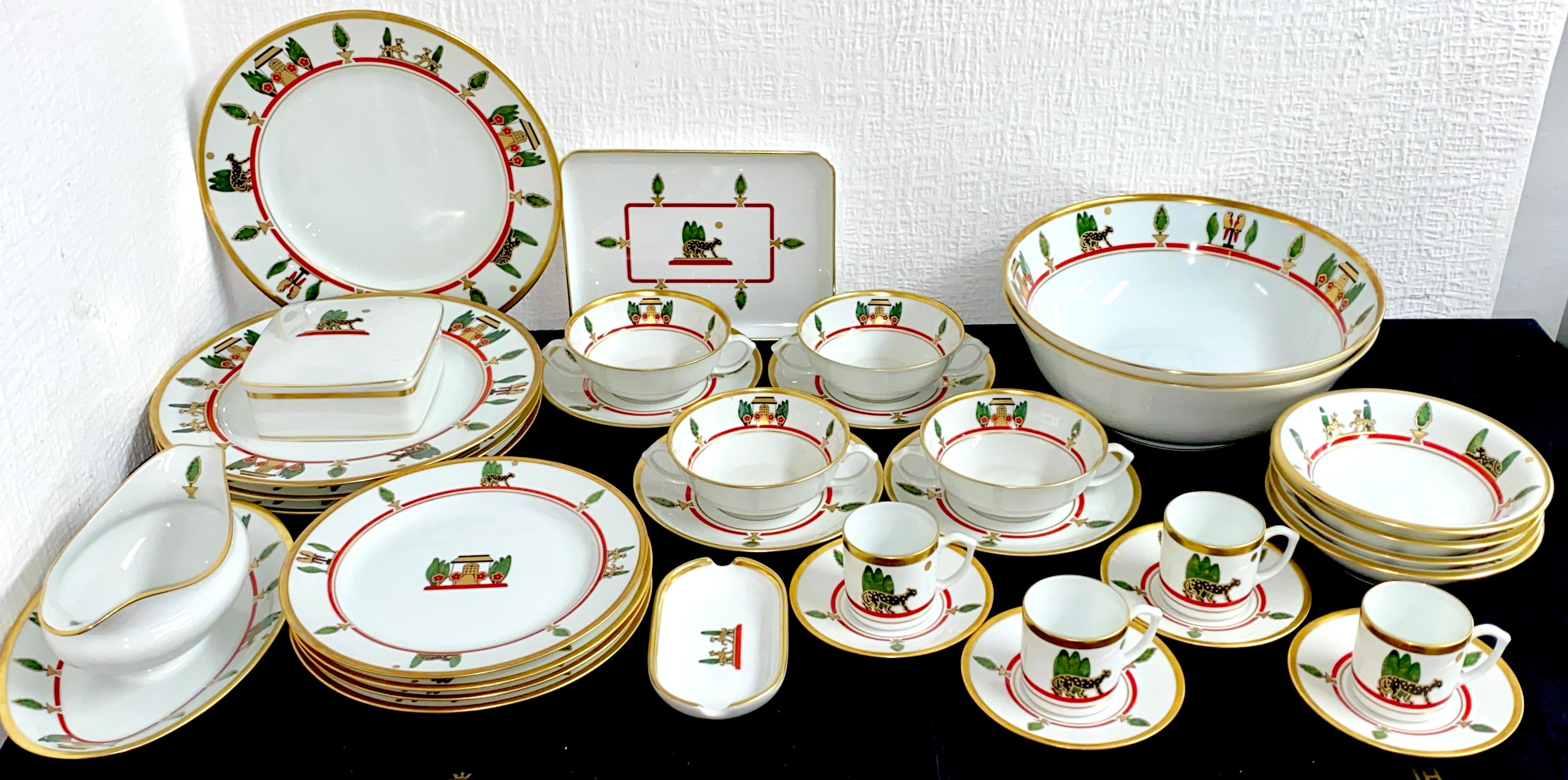 Representative dinnerware from Cartier Limoges. 34 pieces.

Designed 1986. Limoges porcelain, original Cartier decor with black panthers, gold painting and bushes.

Consisting of :

4 large dinner plates 26.5cm
4 dining place 21.5cm
2 large
