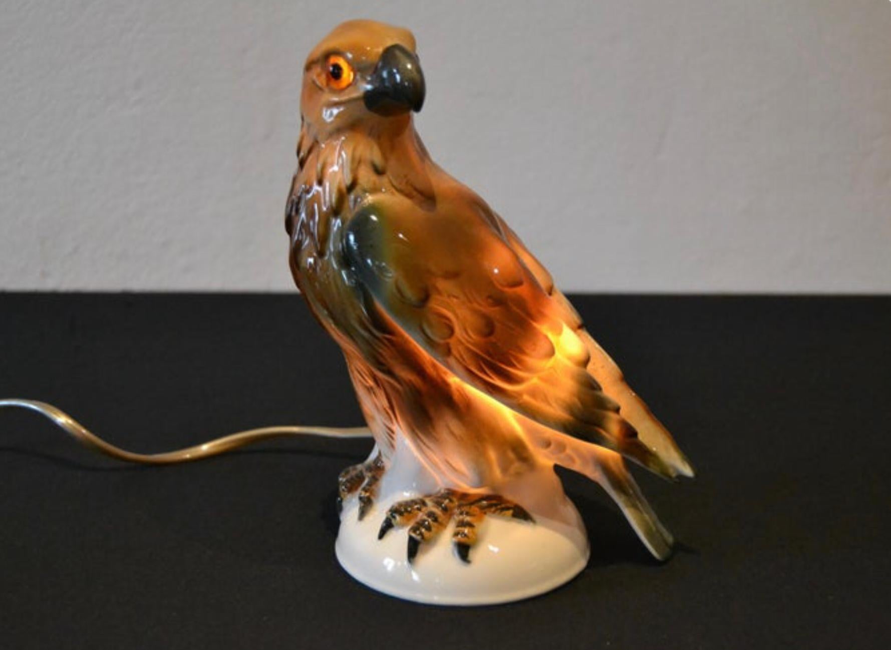 Porcelain eagle perfume light circa 1930s. 
A great looking perfume lamp in the shape of an eagle bird. 
A perfume lamp of a porcelain eagle sculpture with glass eyes.
This animal statue, animal light, bird lamp dates from the Art Deco period where