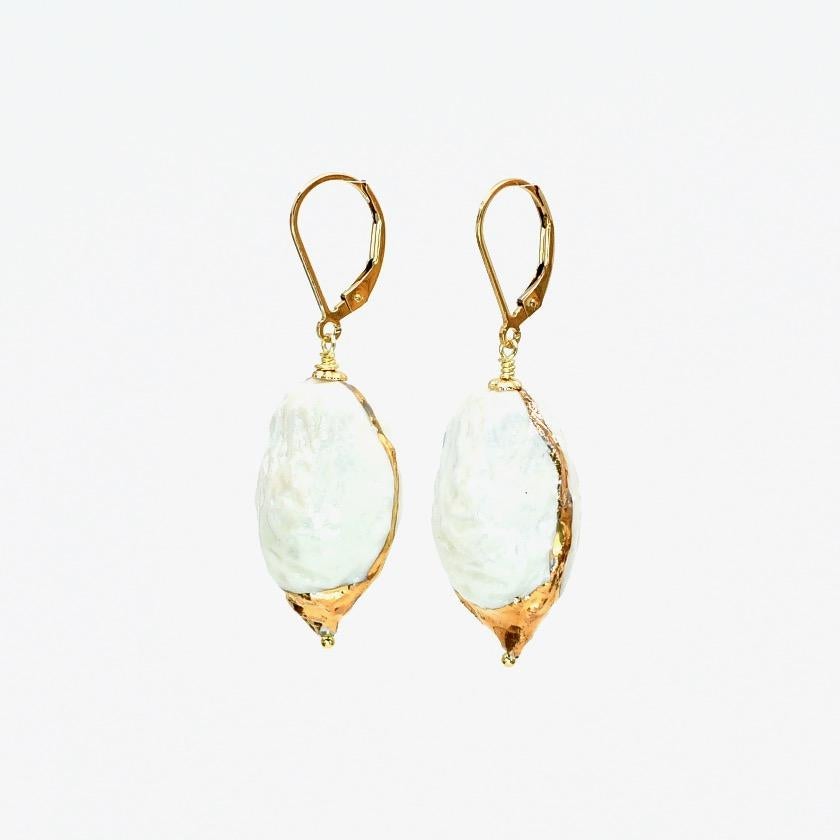 Porcelain  24K gold  Mother of pearl Handmade in London

Indulge in luxury with our AMATA Porcelain Ceramic Earrings. Made from the finest, whitest porcelain and adorned with delicate hand marks of 24k gold and mother of pearl, they resemble the
