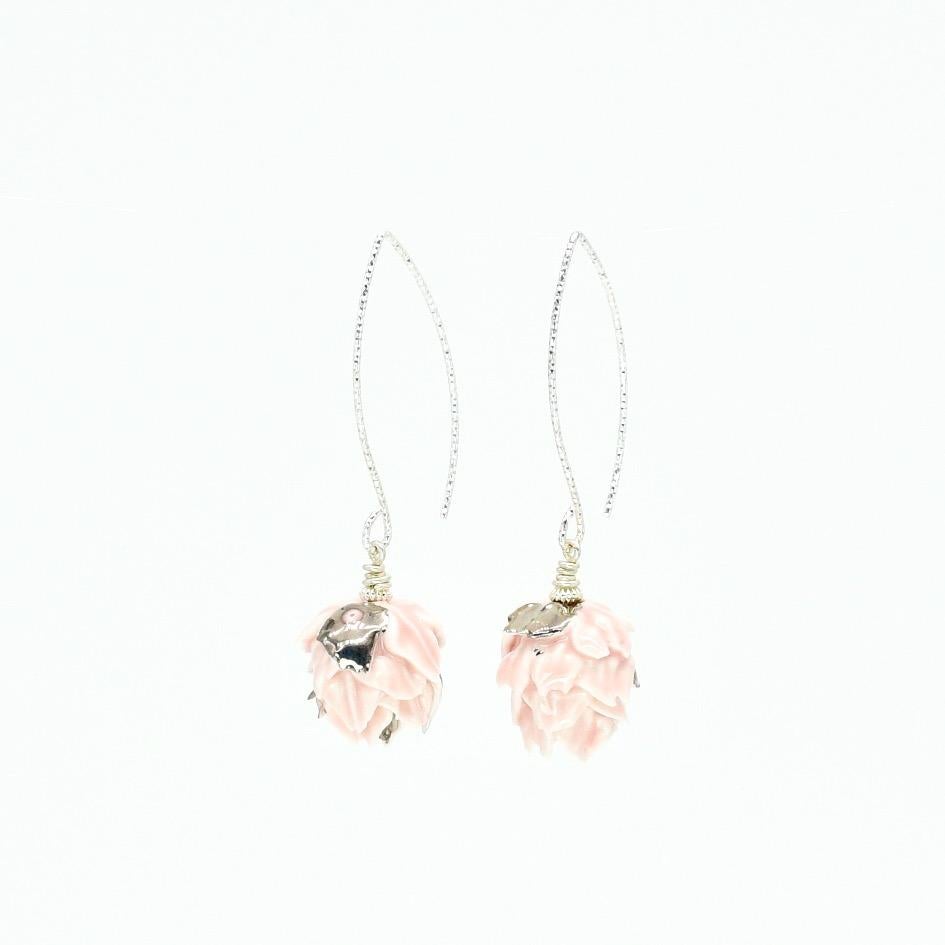 Porcelain  Sterling Silver wires  Platinum  Handmade in London

Introducing FABA Porcelain Ceramic Earrings, crafted from the finest porcelain and adorned with gentle pink glazing. These elegant earrings are fitted on sparkle V-shaped wires, adding