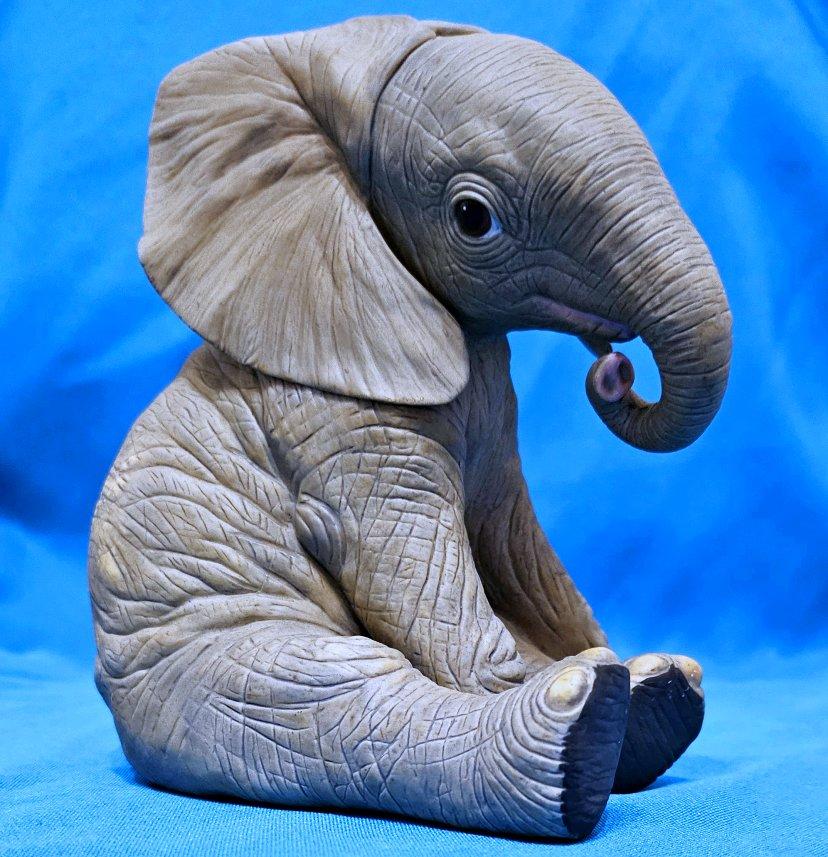 Porcelain Elephant Calf Sculpture by Lenox.
UPDATE: Due to agreement with 1stDibs, we'll be staying through the end of the year.
This beautiful realistic baby elephant figurine measures approximately 6 x 5 x 4 inches. 
It us in good vintage