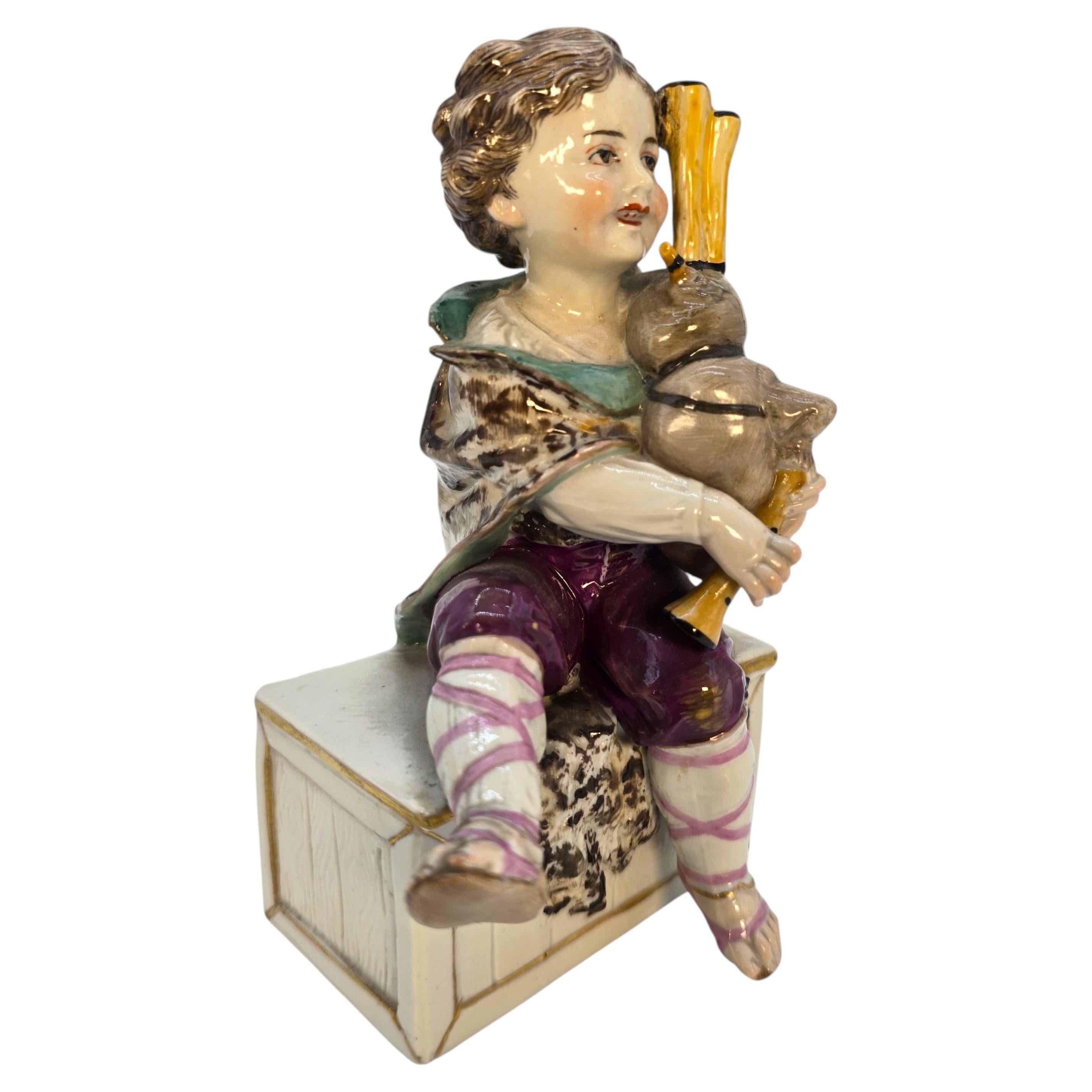 Porcelain figure of a boy playing the bagpipes, Volkstedt Rudolstadt Factory. For Sale