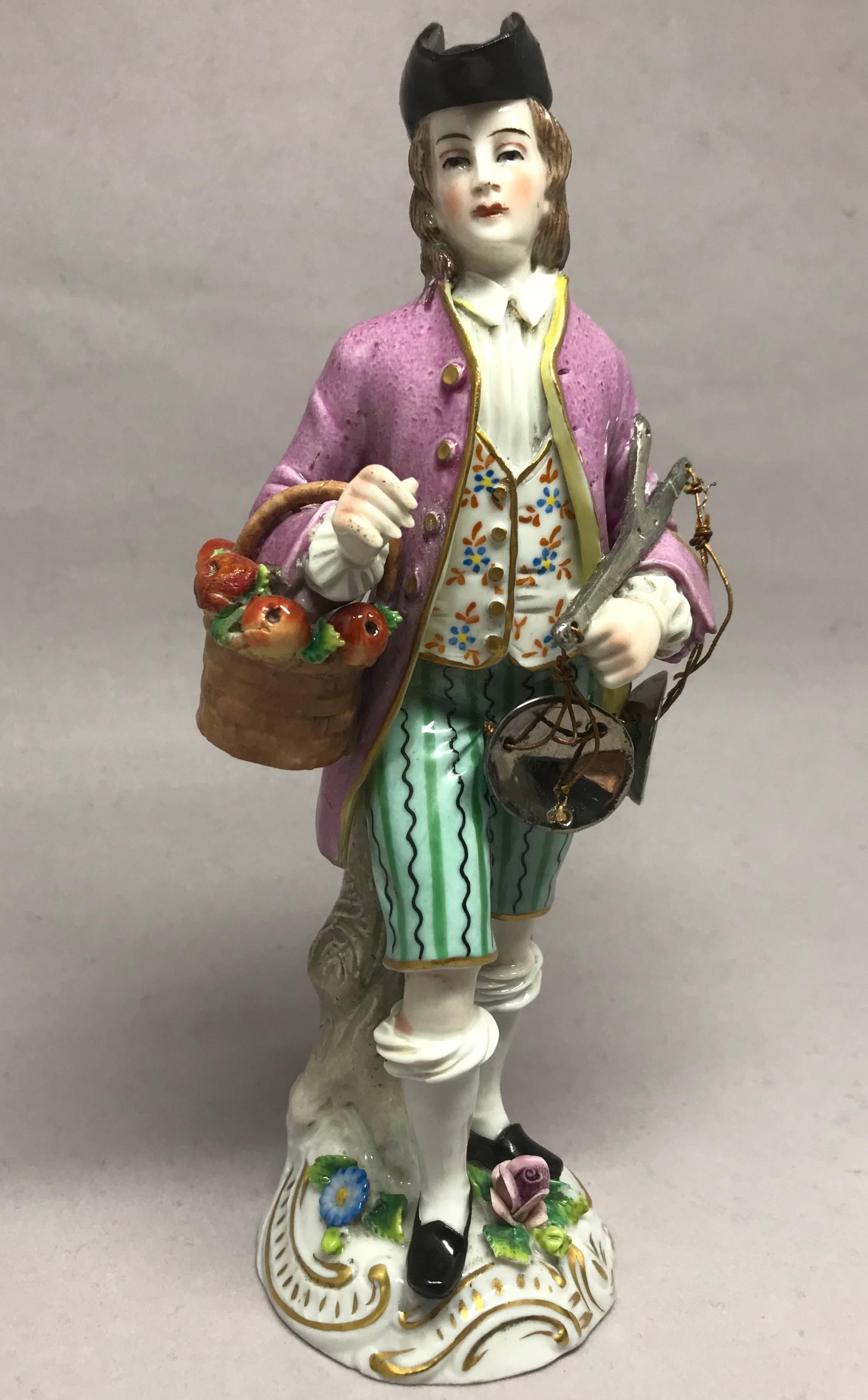 Figure en porcelaine d'un vendeur de pommes. Figurine en porcelaine de Capodimonte représentant un vendeur de pommes avec panier et balance. Marques fallacieuses pour Capodimonte ; italiennes ou éventuellement allemandes. Europe, fin du XIXe