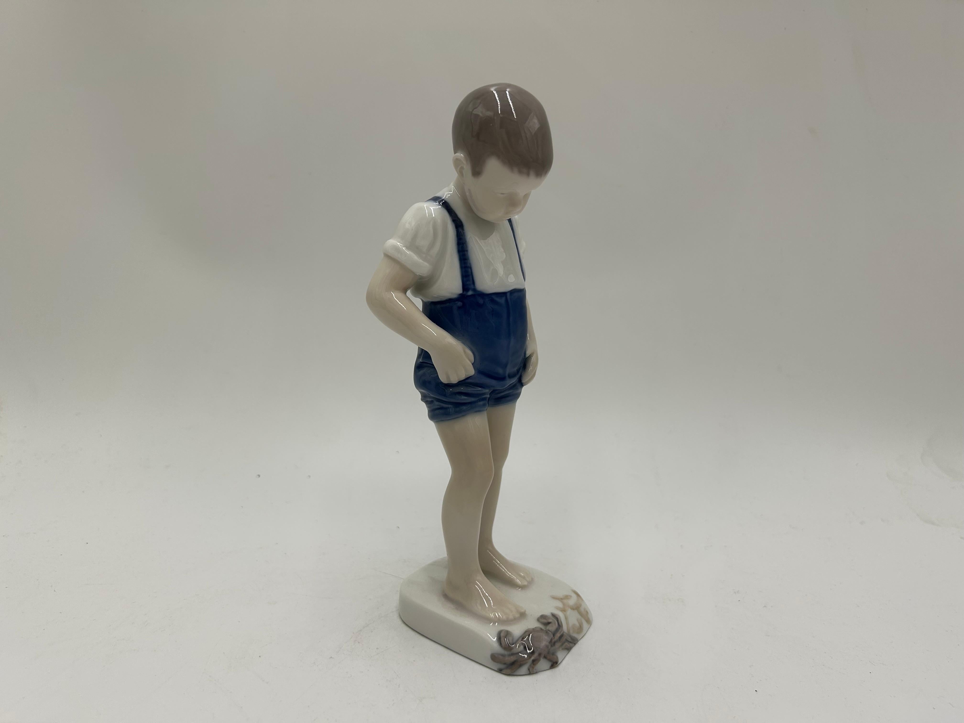 Porcelain figurine of a boy with a crab
Produced by the Danish manufactory Bing & Grondahl.
Mark used in 1948-1952.
Very good condition, no damage
Measures: Height: 20cm
Width: 6cm
Depth: 6cm.