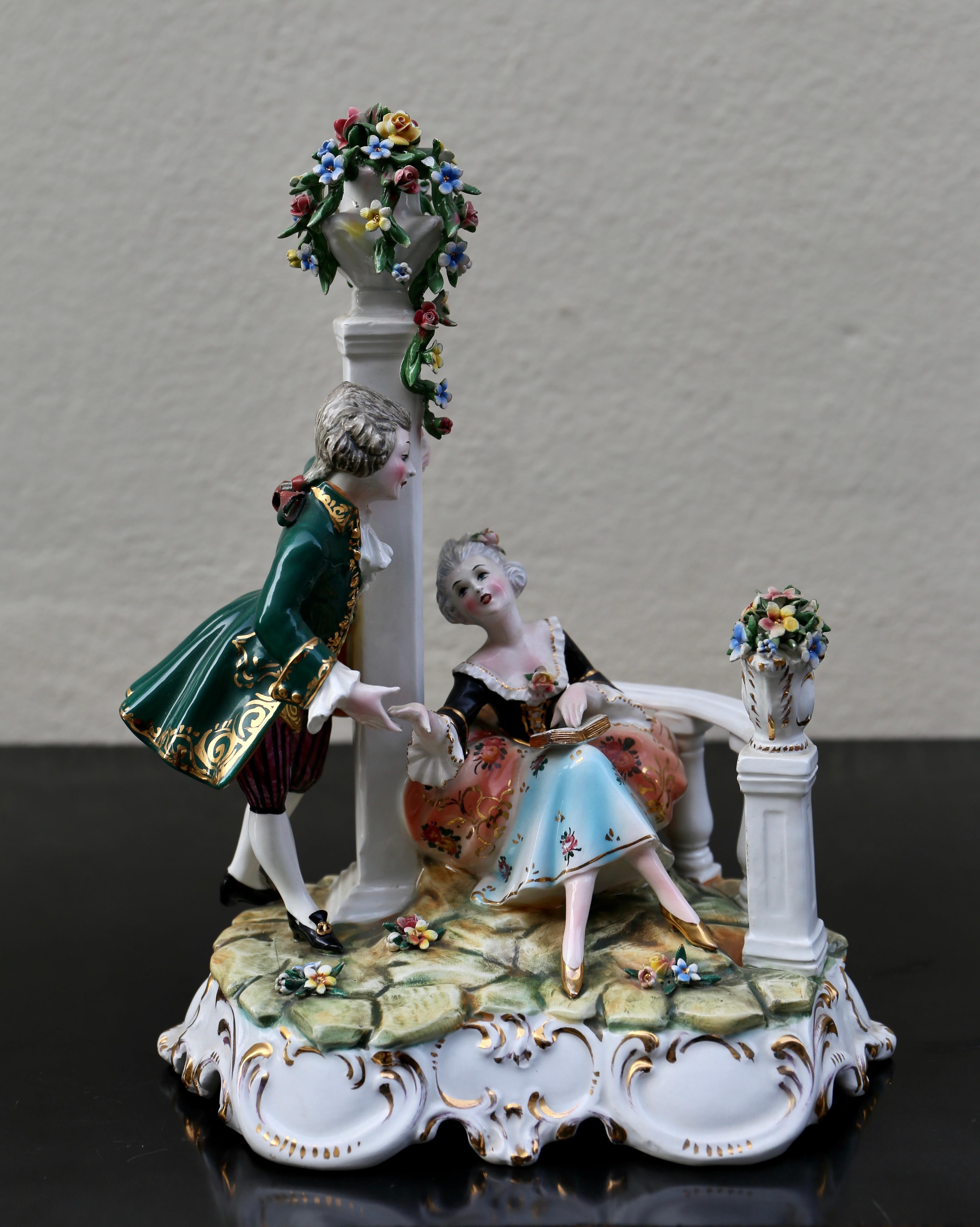 Beautiful porcelain figurine of a romantic love couple, the lustrous colors of verdant green, pinks and a wide range of patinas accentuating their figures and movement.


Height 10.6