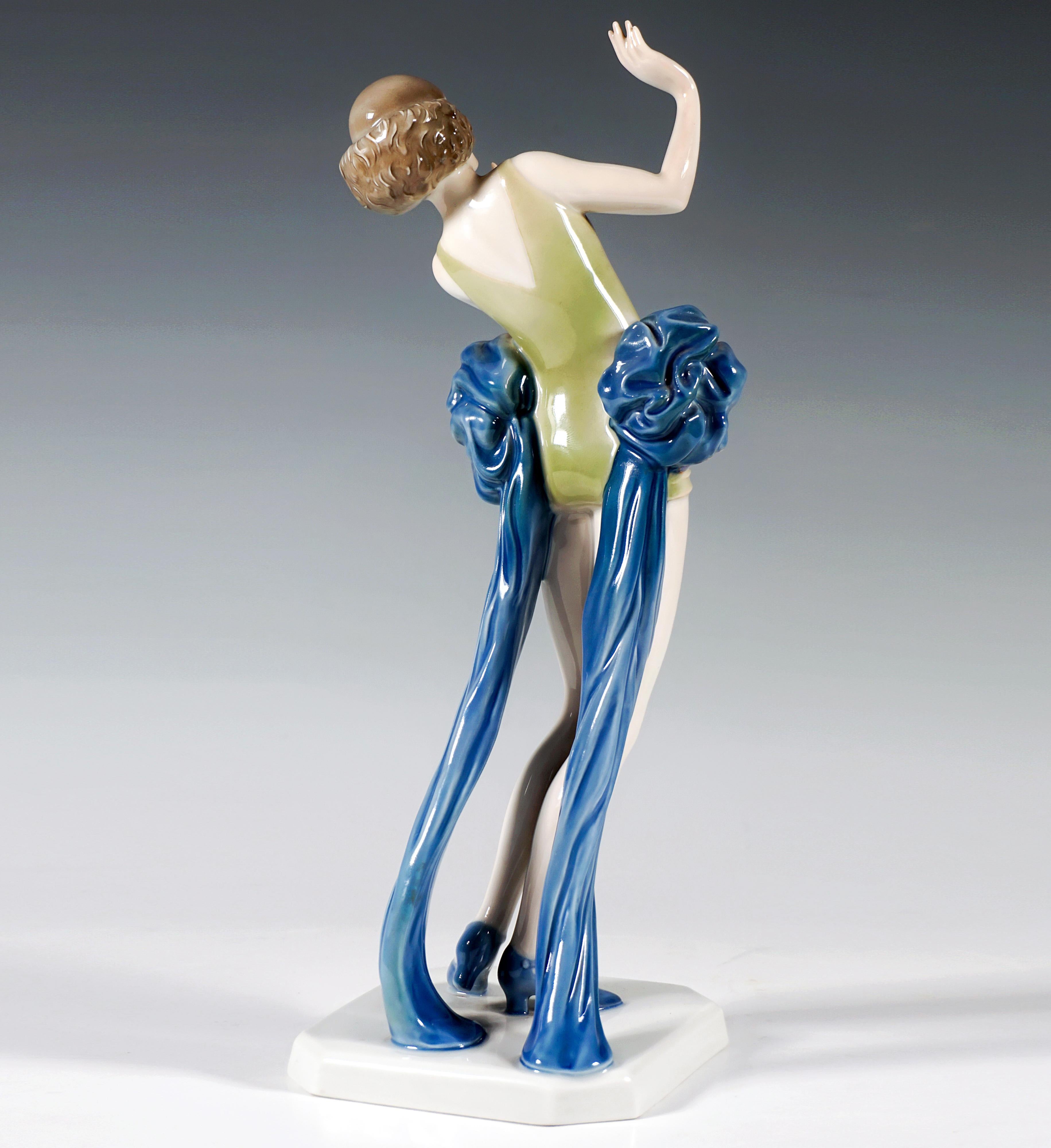 Rare Rosenthal figurine:
Dainty dancer, dressed in a short, sleeveless and legless costume, large ruffles on the left and right hips falling to the floor as long trains, the hair on the top of her head smoothed and curled at chin height, with her