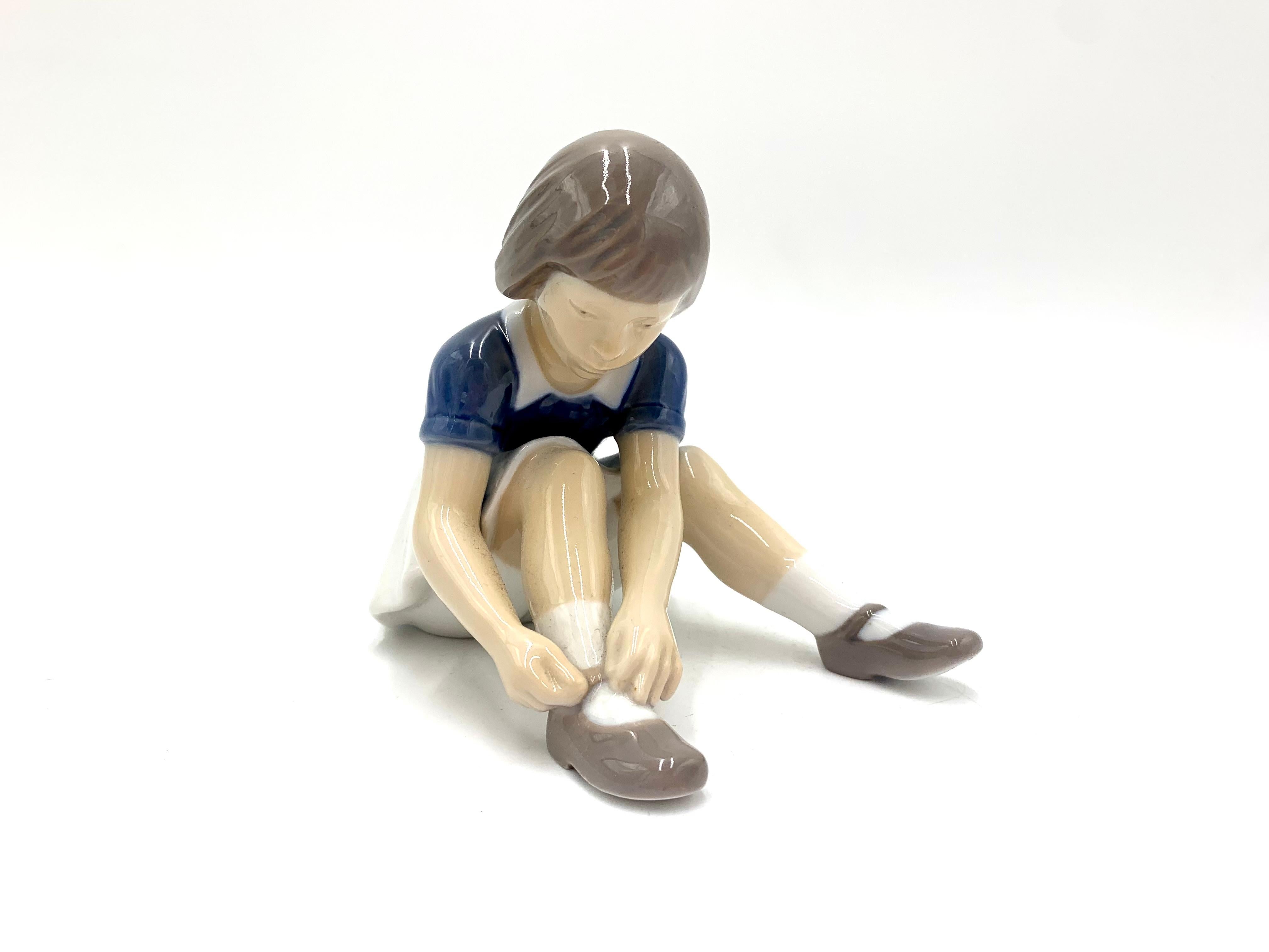 Danish Porcelain Figurine of a Girl Lacing Her Shoes, Bing & Grondahl, Denmark, 1950s