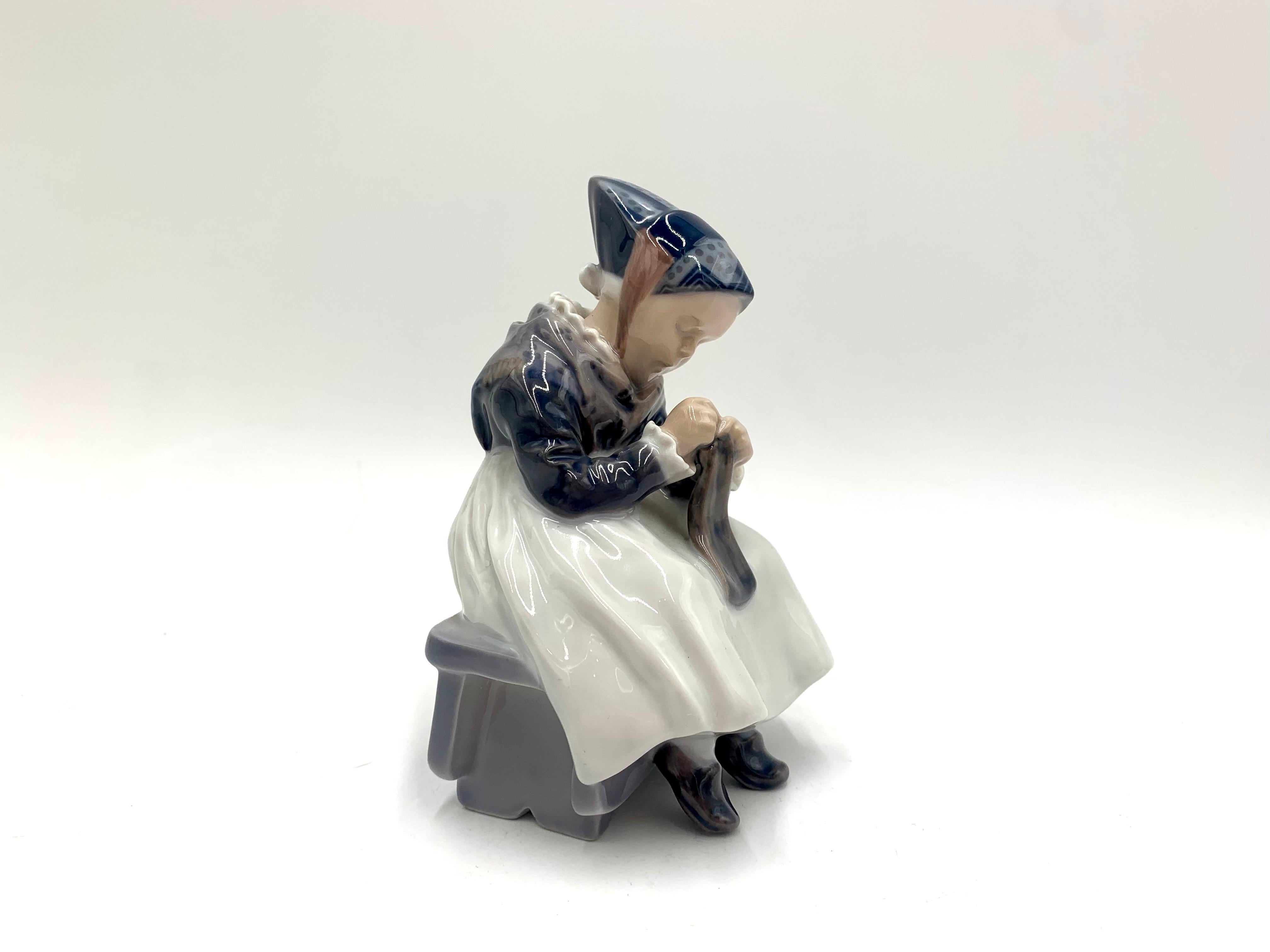 Porcelain figurine of a sewing woman in regional costume.

Made in Denmark by the Royal Copenhagen manufactory

Manufactured in 1957.

Model number # 1314

Very good condition, no damage.

Measures: height 15cm, width 10cm, depth 9cm.