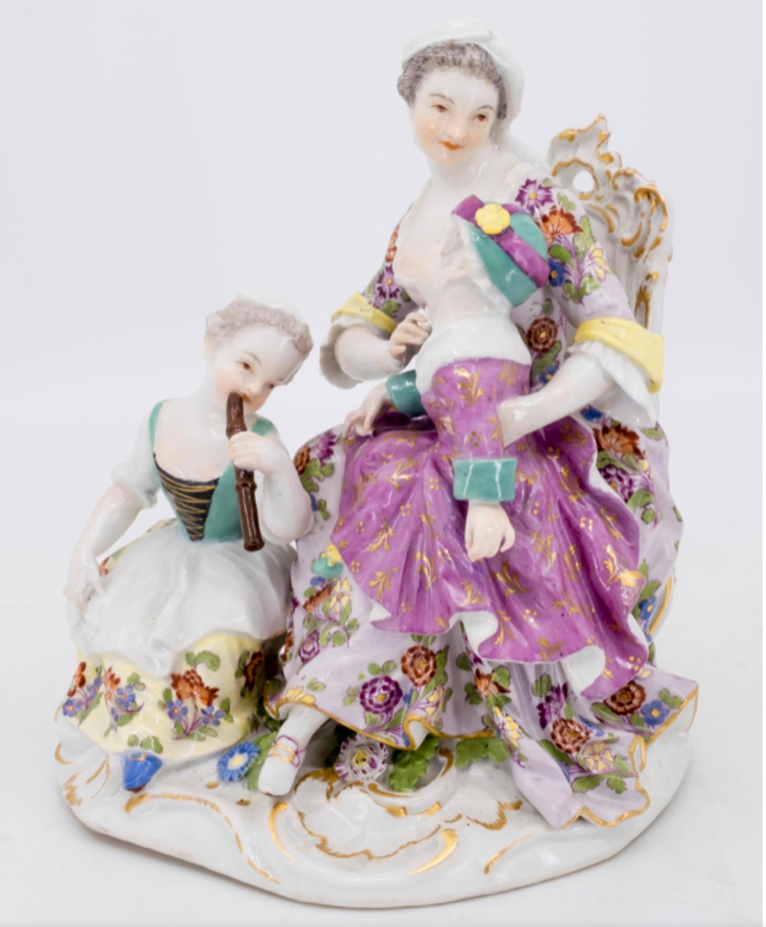 A figurine of a mother and two children, the girl playing the flute
German, Meissen, mid-18th century, marked for Meissen,
porcelain, Germany with double crossed swords in under-glaze blue




