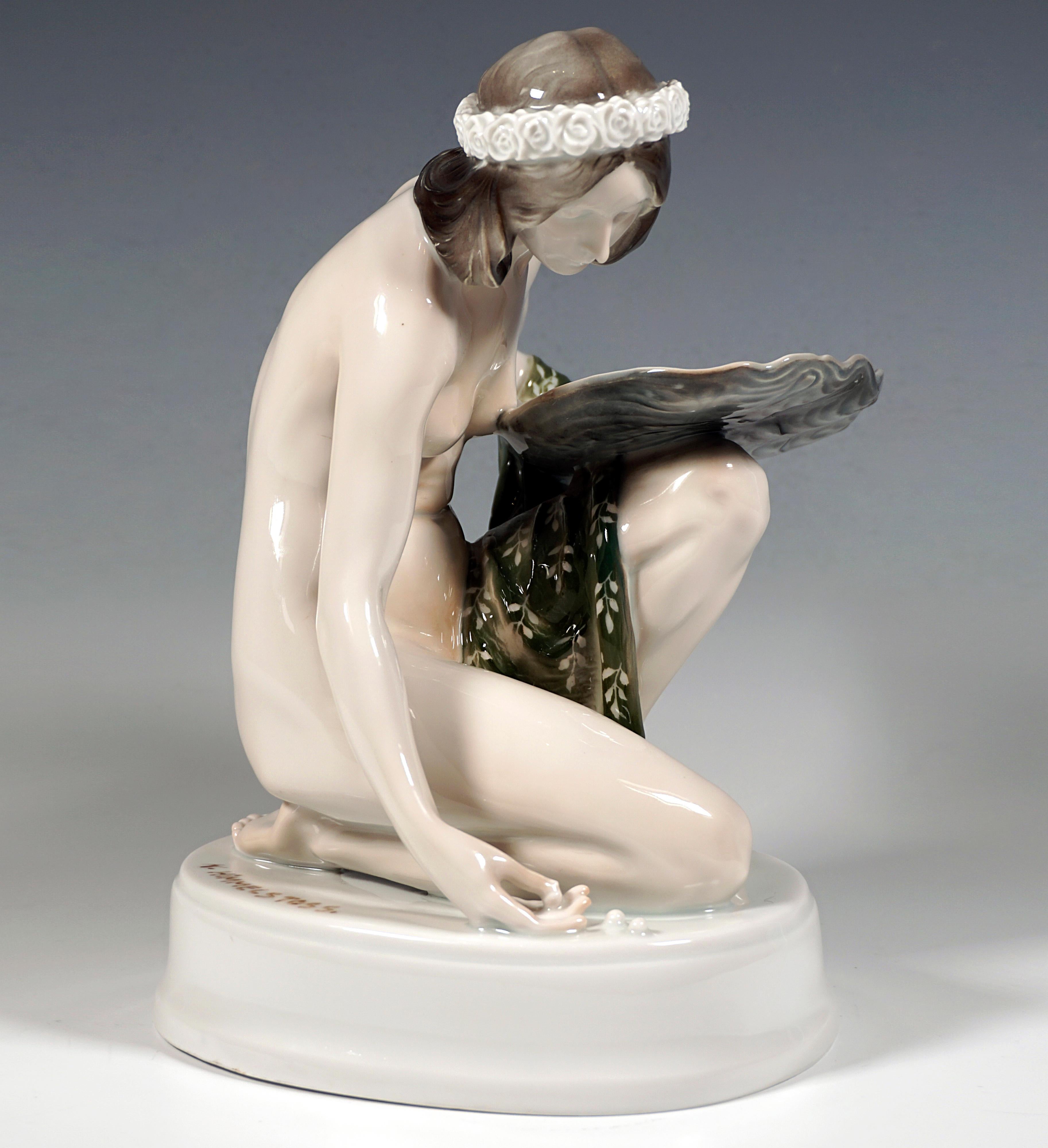 Excellent Rosenthal figurine of the 1920s:
Unclothed girl with a wreath of flowers on her shoulder-length hair parted in the middle, kneeling on the ground with her right leg and picking up pearls from the ground in a bent posture, balancing a large