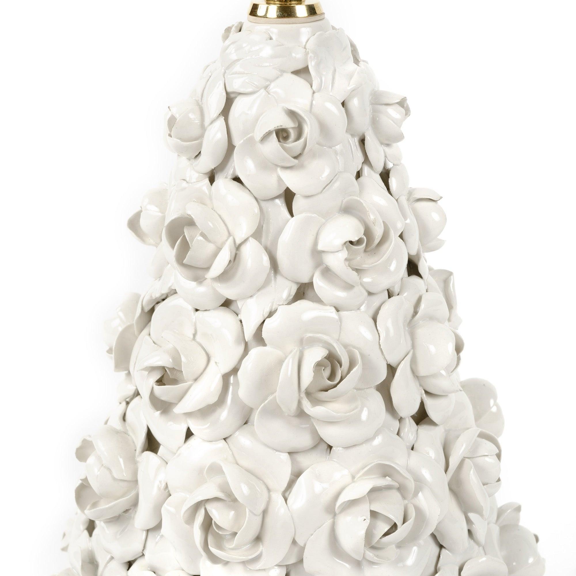 A transparent-glazed ceramic lamp, conical in form, with delicately sculpted porcelain roses applied to its entire surface.