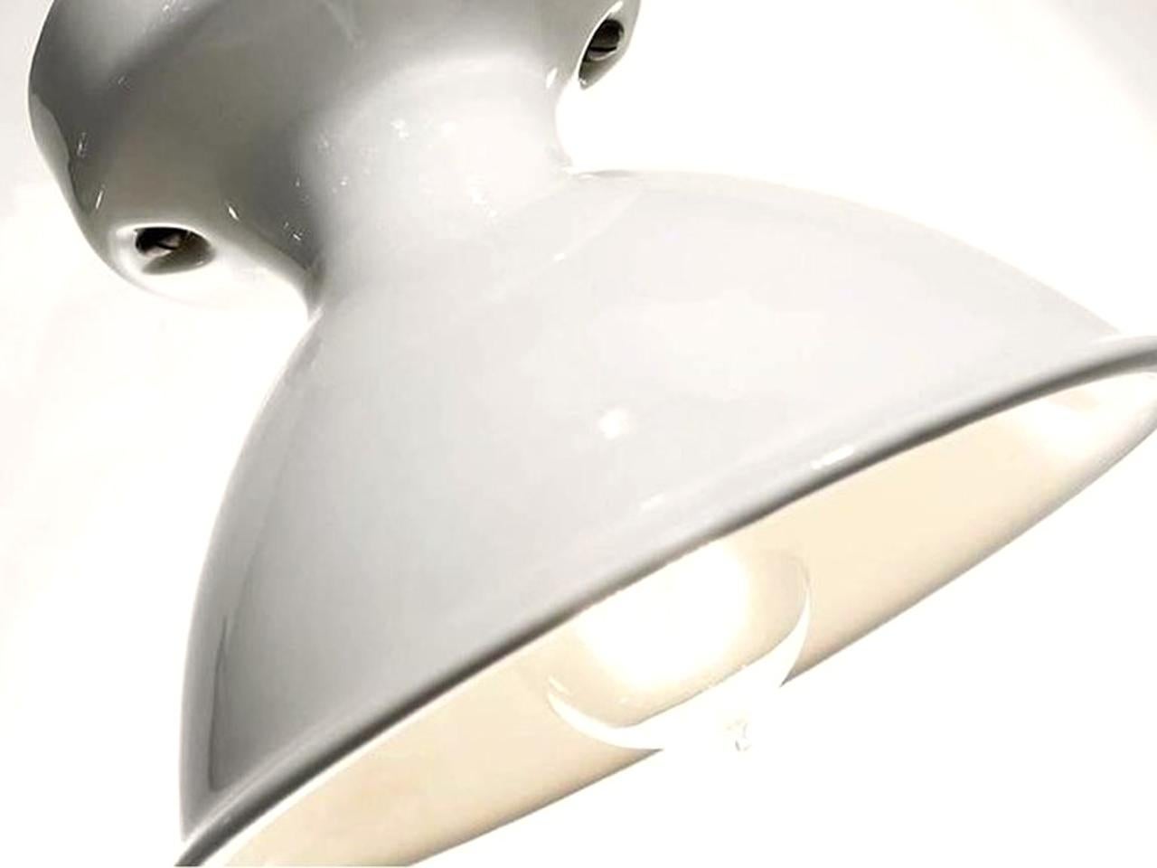 These 1930s style lamps are all cast ceramic with a gloss warm off-white porcelain finish. Nothing is simpler or more elegant then these one piece understated flush mount fixtures.