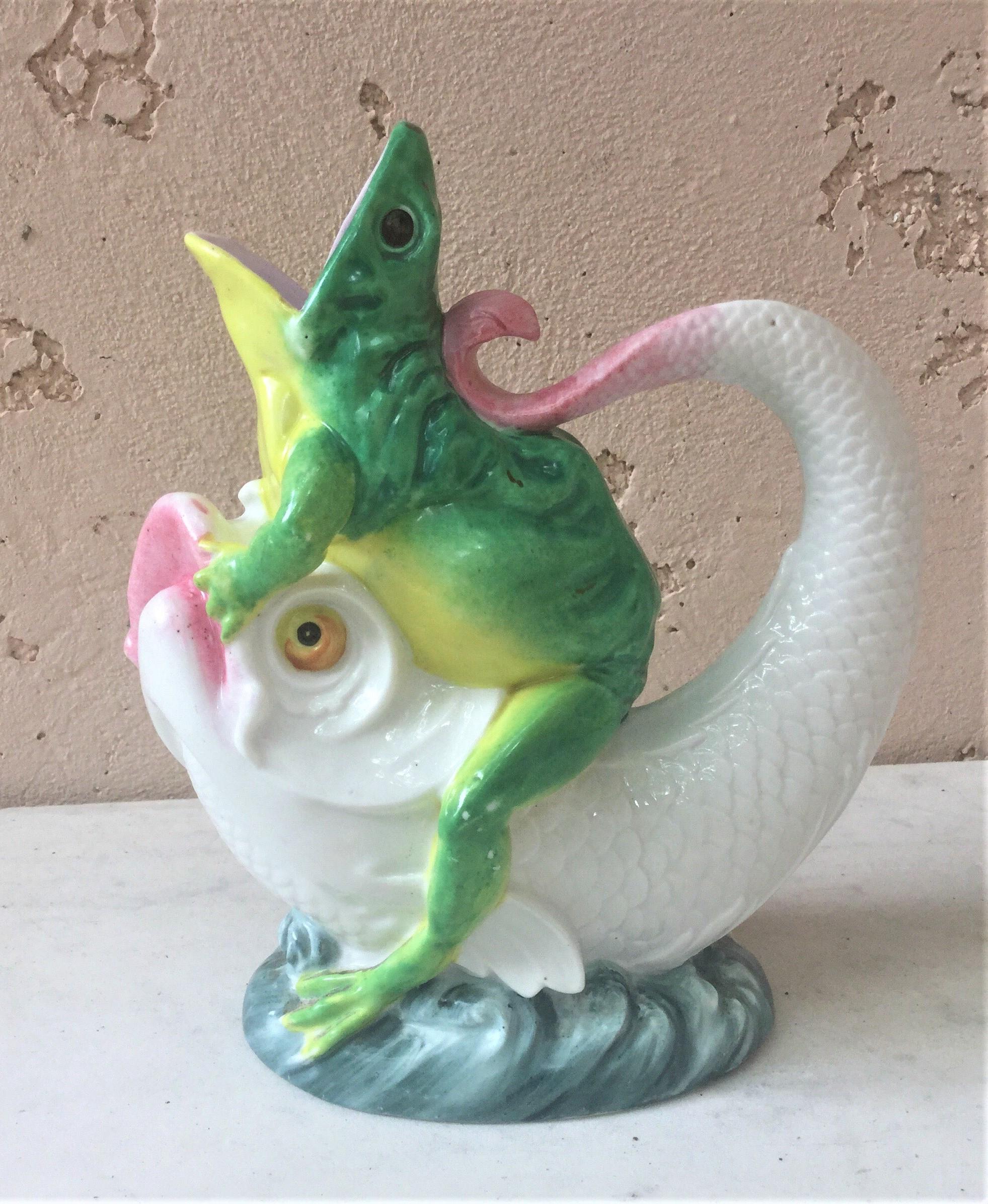 Porcelain jug modeled as an open mouthed frog riding a stylised fish riding waves circa 1870 (shape number 1971)
Reference / A similar example in Majolica was sold at Christie's (November 2005).
  
