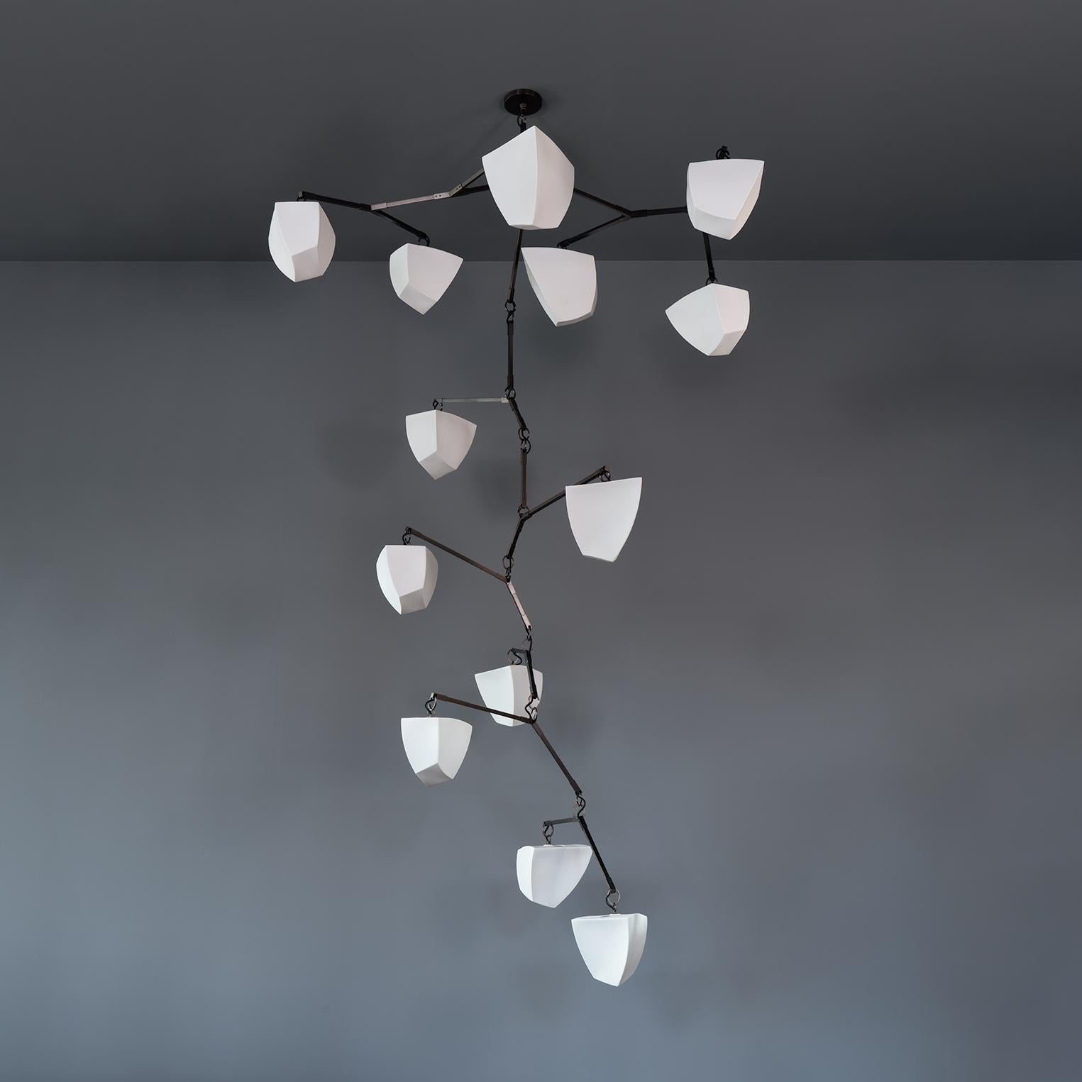 Galaxy 13: Porcelain Mobile Chandelier is a large mobile chandelier with thirteen handmade translucent porcelain polyhedron shades in 2 sizes. 

This configuration was designed to float horizontally and vertically extending in two directions and