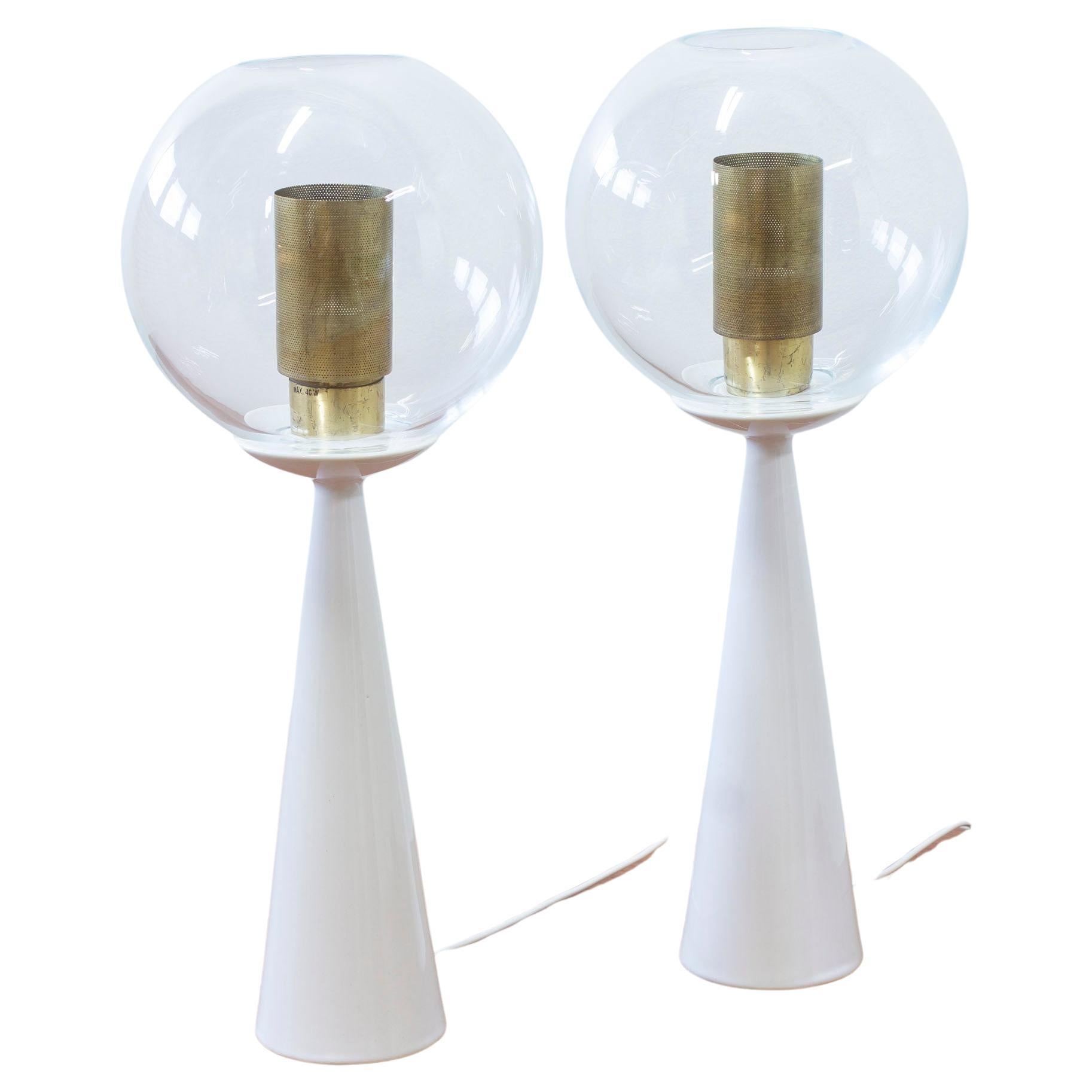 Rare pair of table lamps designed by Hans-Agne Jakobsson. Produced in Sweden by his own company during the 1950s. Made from bone china porcelain. Clear glass shades and perforated brass diffusers. Very good vintage condition with light age related