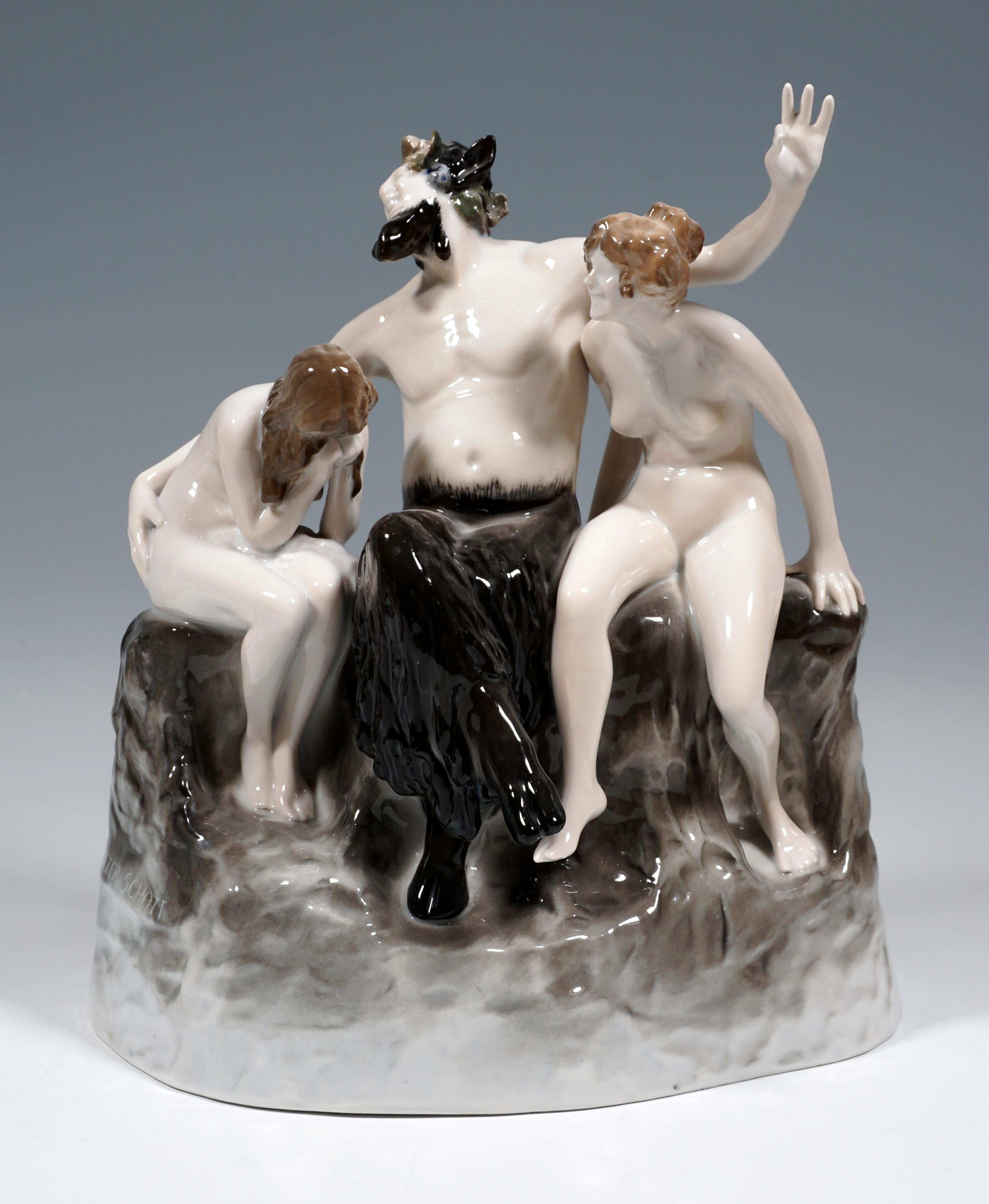 Admirable Art Nouveau Figurine by Rosenthal.
Laughing faun with crossed goat legs flanked by two nymphs sitting on a rock plinth. While the female figure on the left buries her face shamefully in her hands, the second looks over at her, laughing.