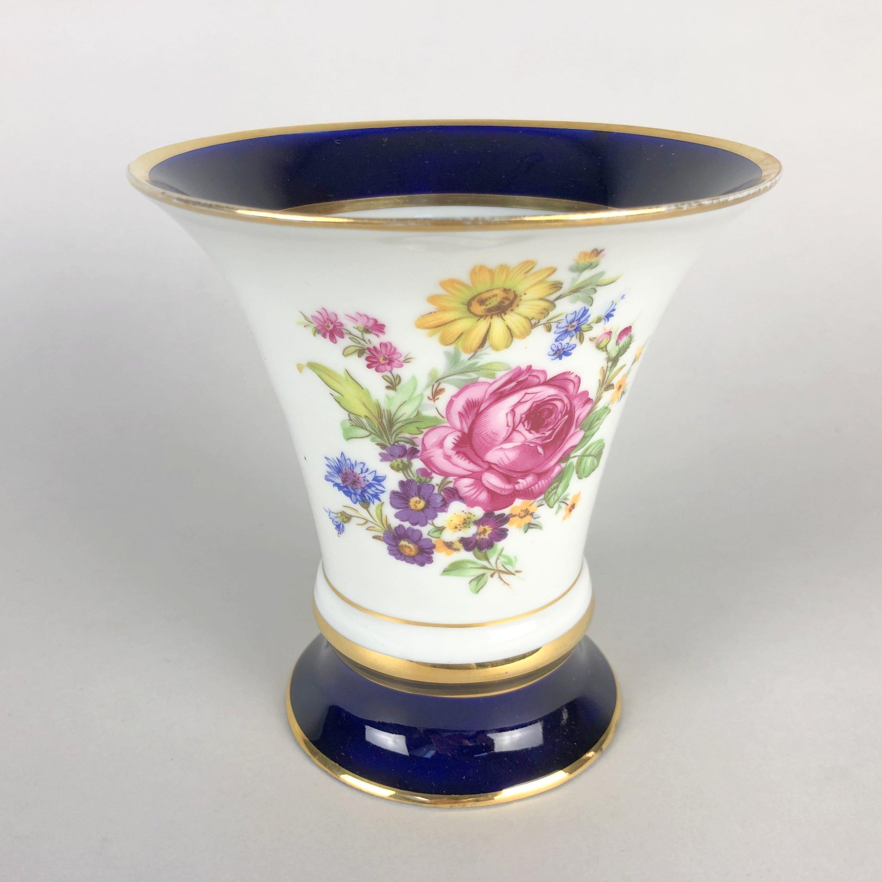 Royal Dux porcelain trumpet vase with blue and gold rims and borders and floral decoration. It has the famous Royal Dux pink clay applied triangle. Made in former Czechoslovakia in the 1960's.