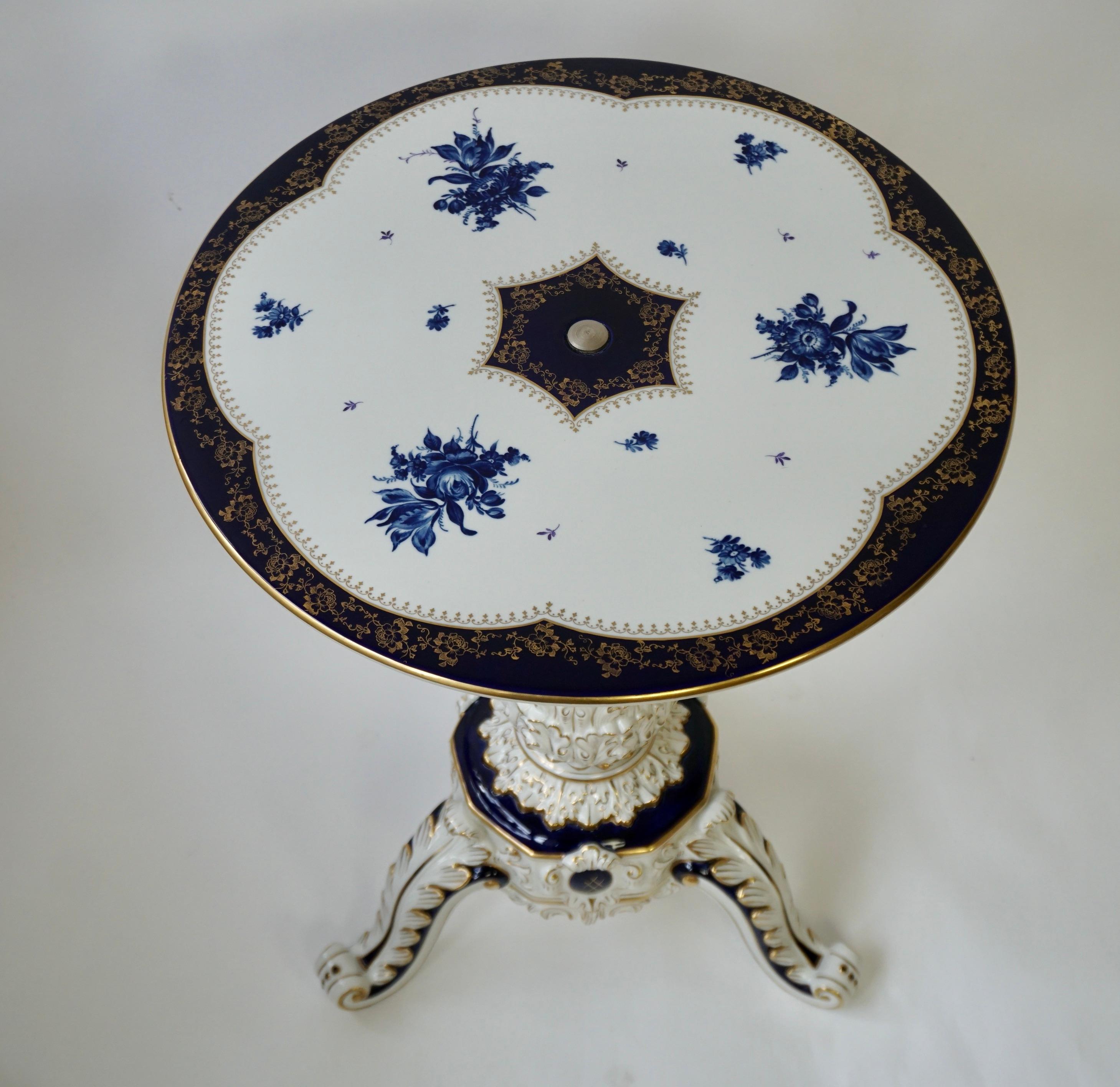 Vintage coffee table made of cobalt porcelain in rococo style.  

Artist's signature
RMR 1817 Dresden, Germany.   

Hand-painted floral decoration in cobalt blue and gold against a white background.   

Porcelain painted with cobalt paint is