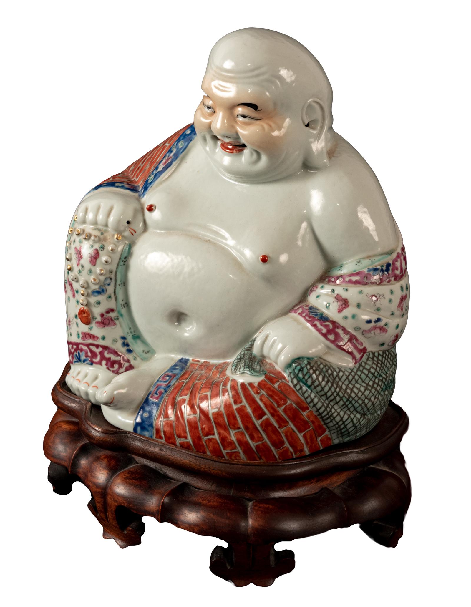 A very fine porcelain Hotei or Laughing Buddha statue on conforming carved wood stand (circa 1900) late Qing period.