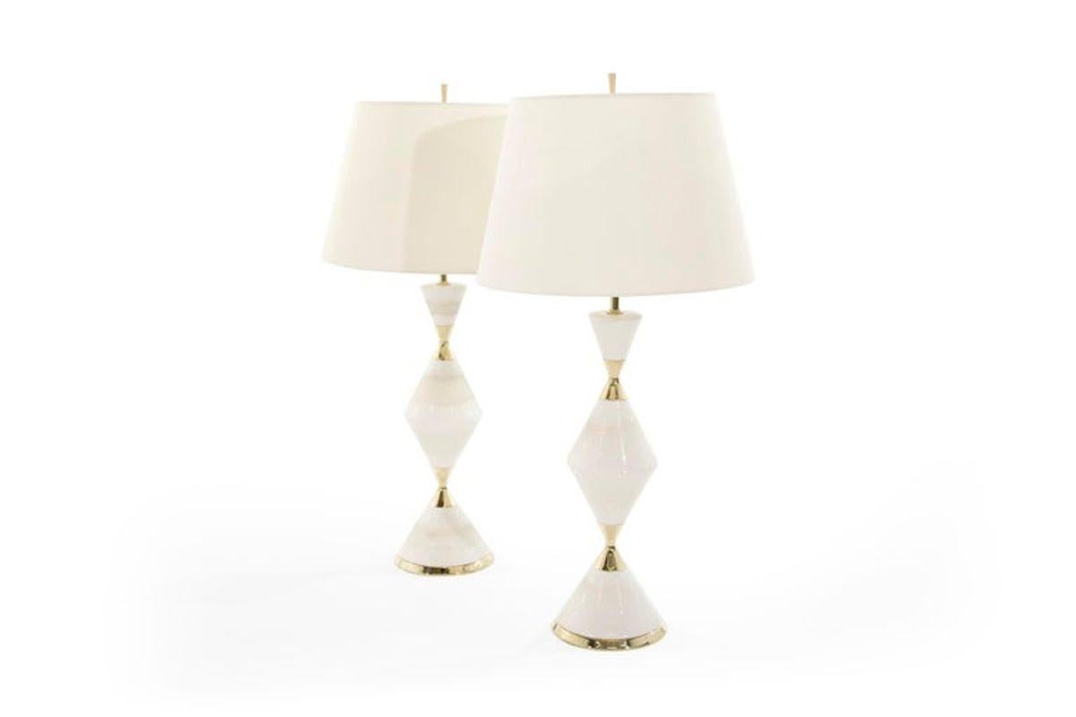 Stunning pair of vintage table lamps that exude sophistication and style - a true collector's item for those who appreciate mid-century modern design. These lamps were designed by the legendary Gerald Thurston for Lightolier in the 1950s and are a