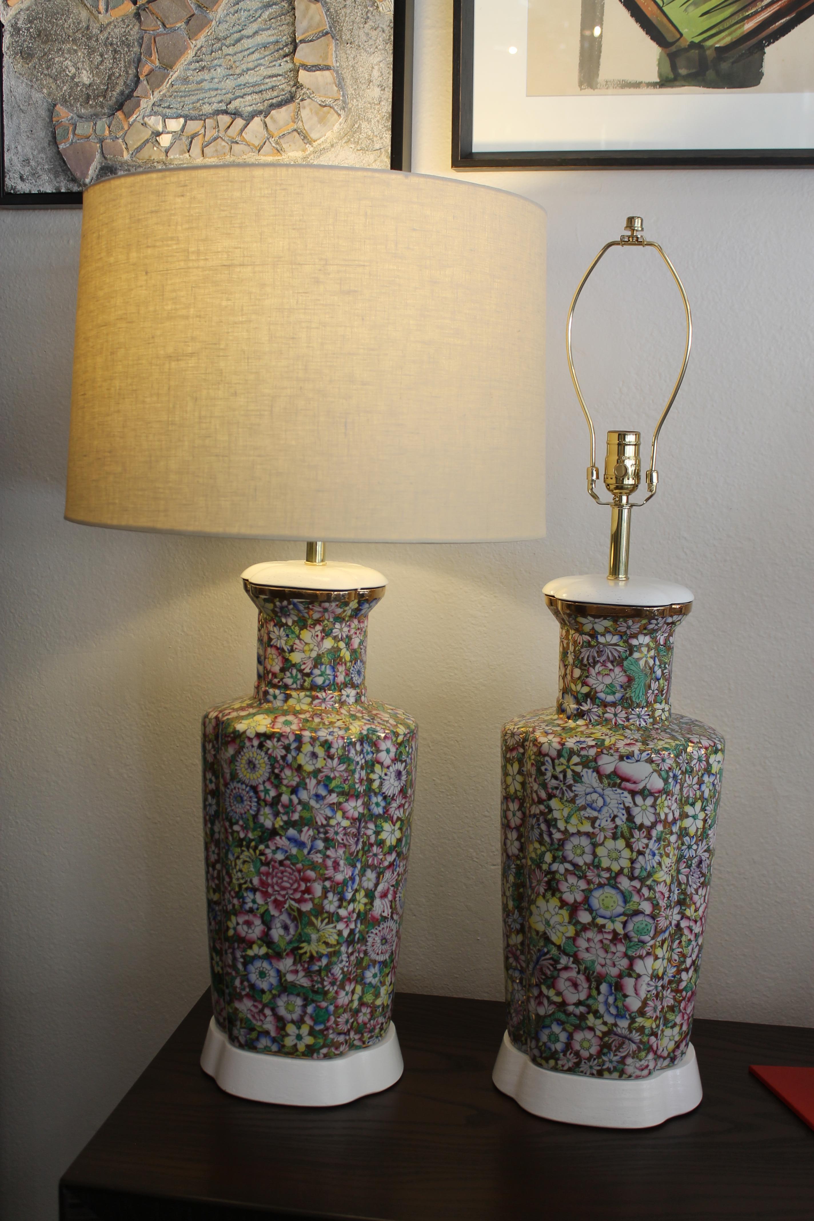 Hand painted flowers on porcelain resulting in a stunning pair of lamps. Stamped on the bottom during rewiring says ‘Japanese Porcelain Ware Decorated in Hong Kong’. Lamps measures 23.5” high from base to the bottom of socket. Ceramic portions 8.75”