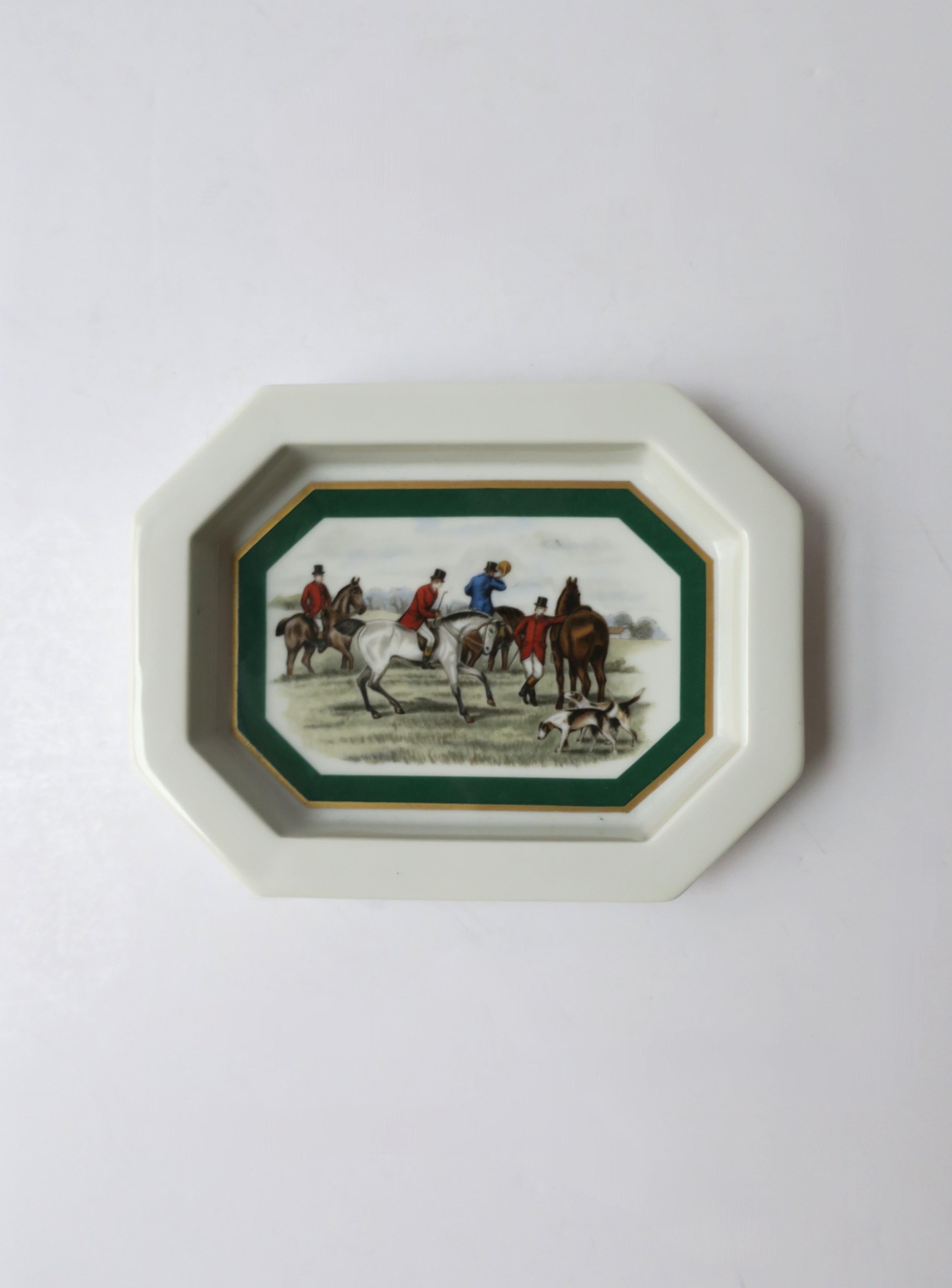 A porcelain jewelry dish with equestrian horse scene, circa mid-20th century, Europe. An octagonal jewelry dish/small vide-poche with gold and emerald-green detail framing scene of equestrian riders, horses, and hound dogs. In the style of Ralph