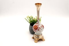 Porcelain jug with silver neck and base, cut with reliefs and applications