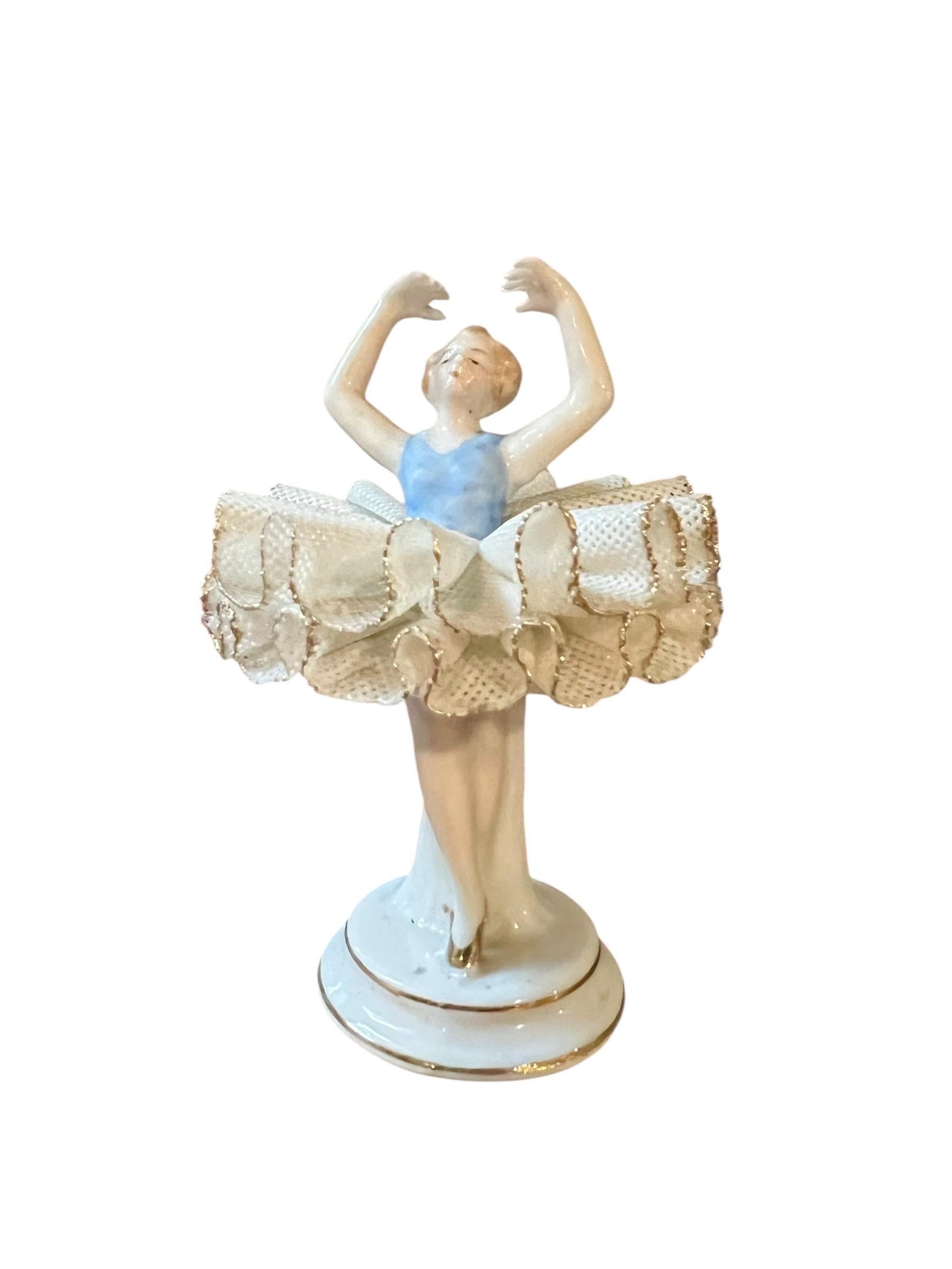 Encantadora figurita de porcelana de pasta dura que representa a una bailarina de ballet clásico en una pose con los brazos levantados. Fabricada en Turingia (Alemania central), muy probablemente en la fábrica de Sitzendorf, famosa por sus figuritas
