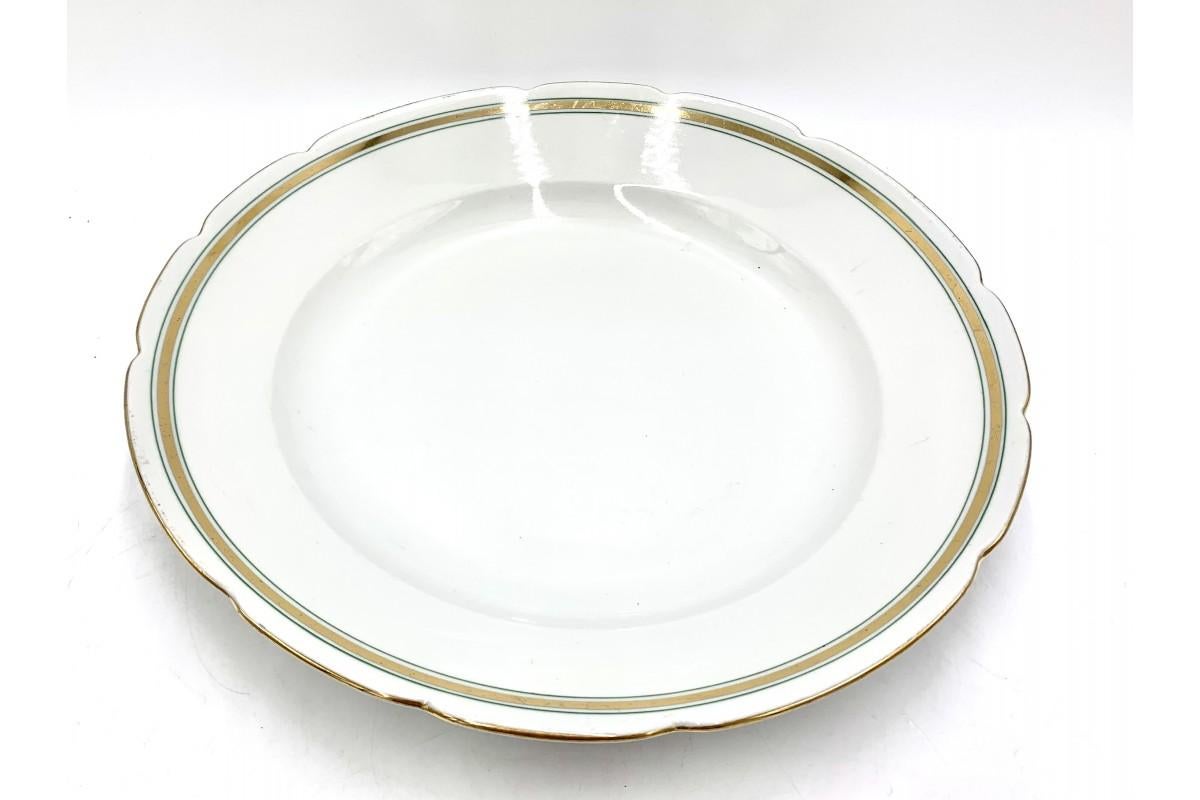 A large porcelain plate produced by Fabryka Porcelany Cmielów in Poland in the 1960s. The edge is decorated with green stripes and gilding.

Very good condition, no damage

Measures: height 5 cm, diameter 33 cm.