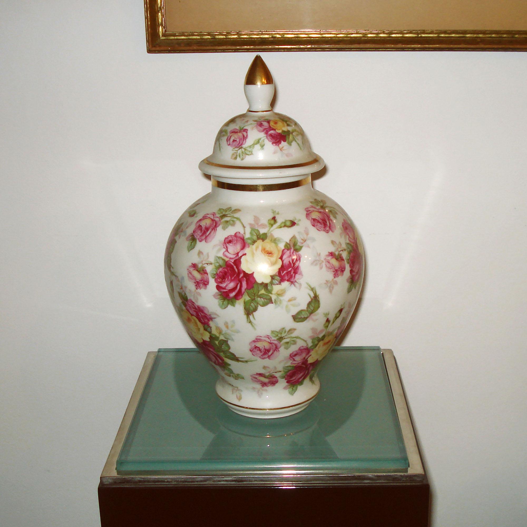 Porcelain urn with lid, hand painted decor of roses, enhanced with 24K gold painted details. Made by Bavaria Schumann, Germany 1940s. Marked on the bottom.
Dimensions:
 Total height, including lid 29 cm (11.5 in), Diameter 16 cm (6.3 in)

