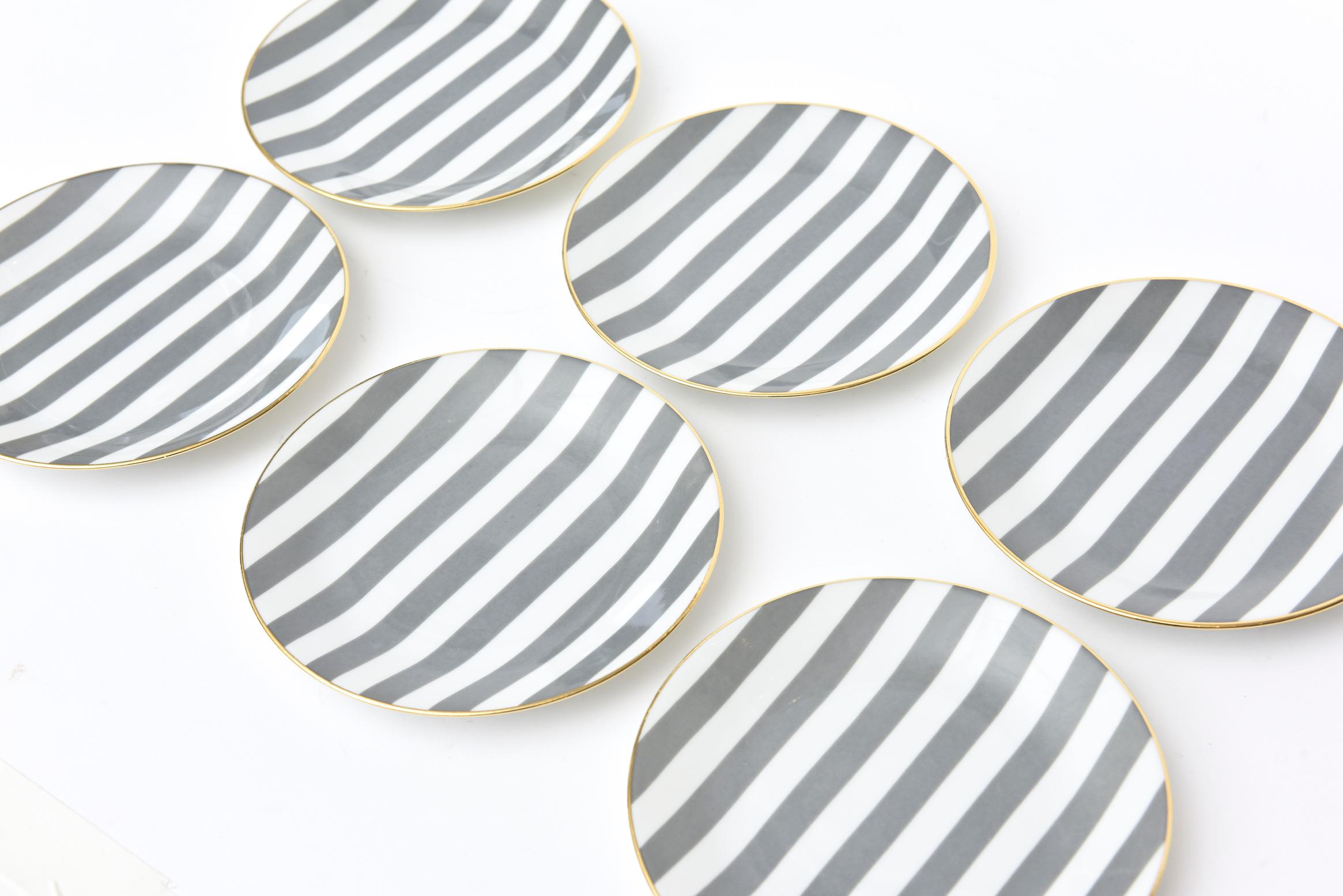 These chic and elegant set of 6 gray and white striped desert and or appetizer Limoges porcelain plates are rimmed with gold. They are signed and numbered and were made exclusively for Neiman Marcus in the 1970s by Philippe Deshoulières. Hand