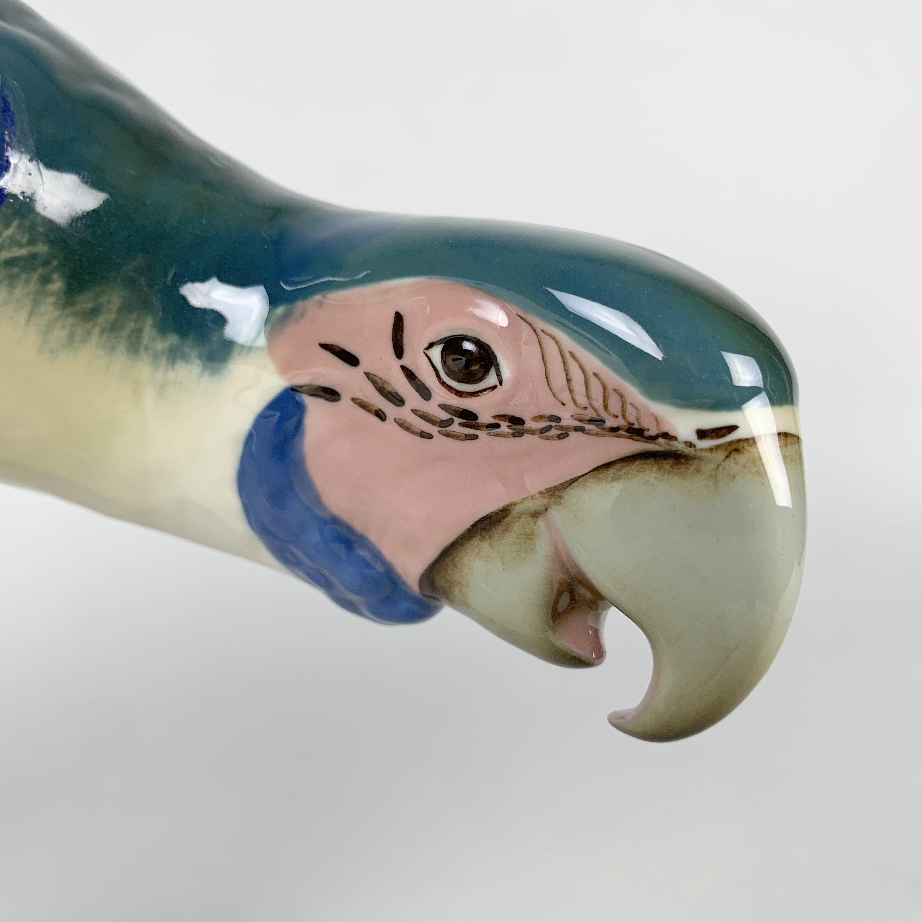 Midcentury porcelain parrot, made and marked by Royal Dux in Czechoslovakia and in the 1960's. All the imperfections are shown in the photos. 
The item is approximately 21 cm (8.27 inch) high, 39 cm (15.36 inch wide) and 10 cm (3.94 inch) deep.
