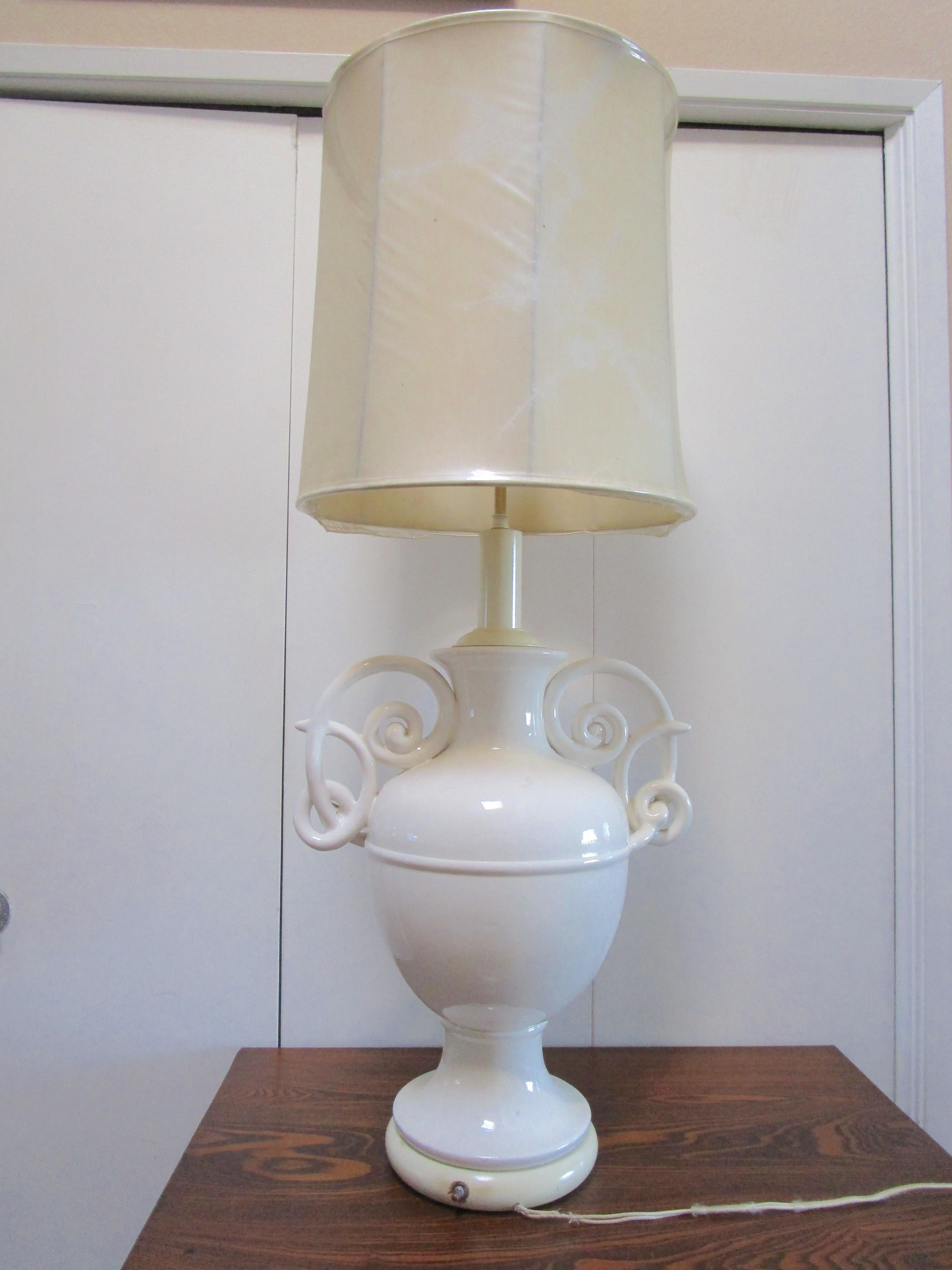 Monumental blanc de chine lamp is statuesque at 44 inches tall with dual sockets and a on / off switch at the base with the original silk cord. This piece exudes Art Nouveau form and style. But the lamp design is influenced by the designer
