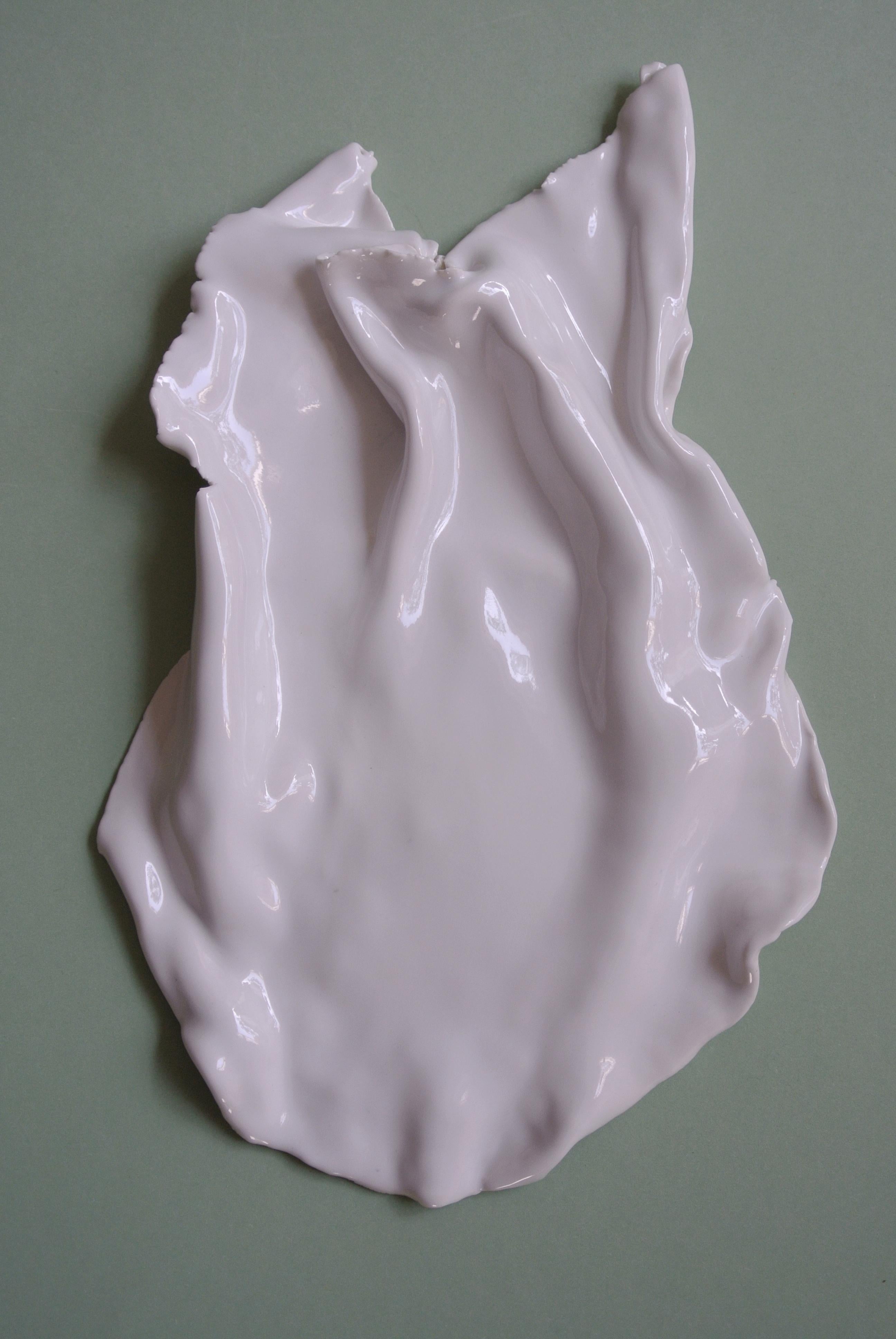 Thin porcelain object with glossy white glaze in an
asymmetric and uneven shape. Glazed only on the surface. 
Part of an ongoing series of one off porcelain paper weights.
      