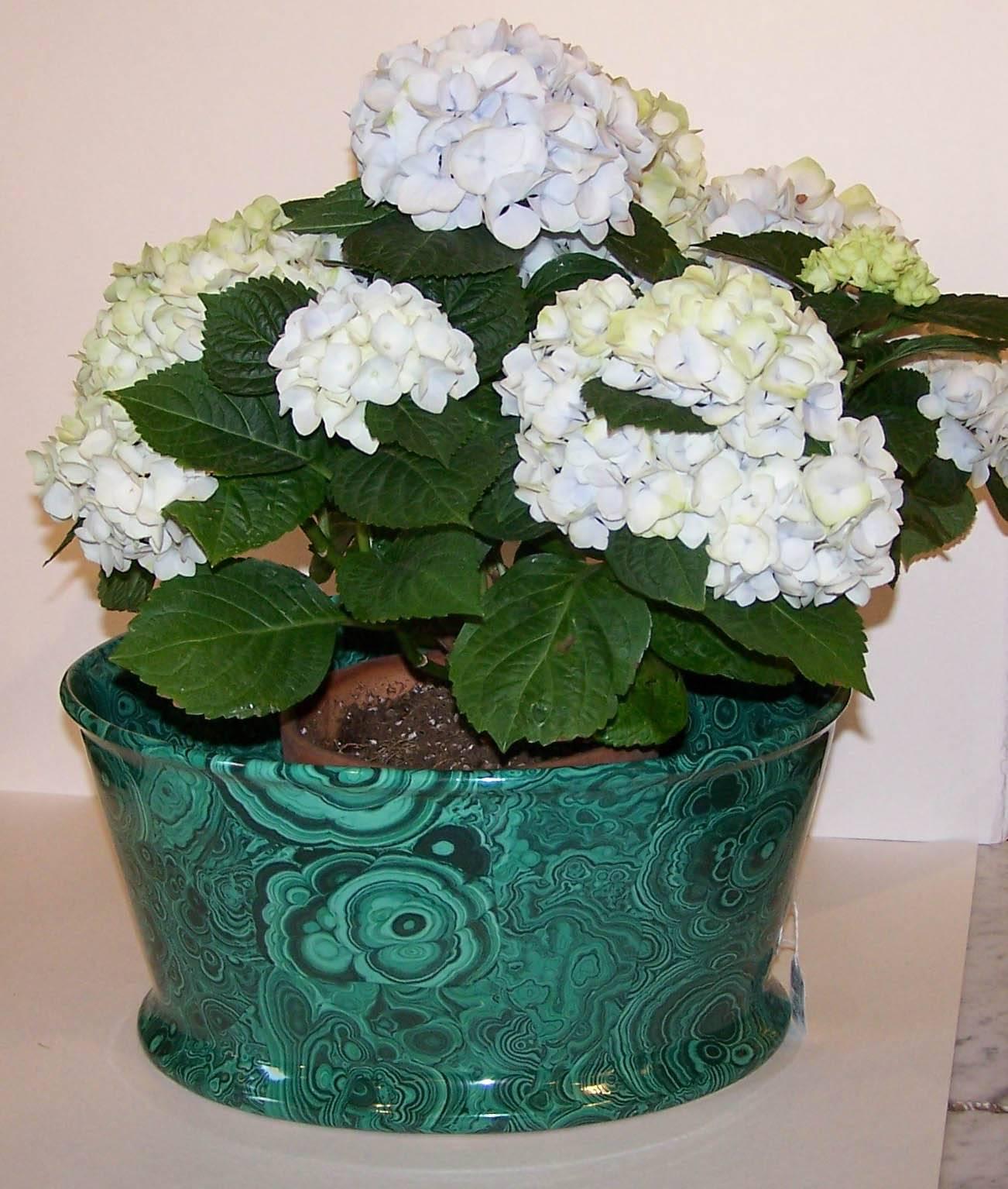 We are pleased to offer this large porcelain planter with malachite decoration. The overall green color makes it ideal for holding flowering plants (see image #2). Any flowering plant will look great. A large orchid would work well here. An