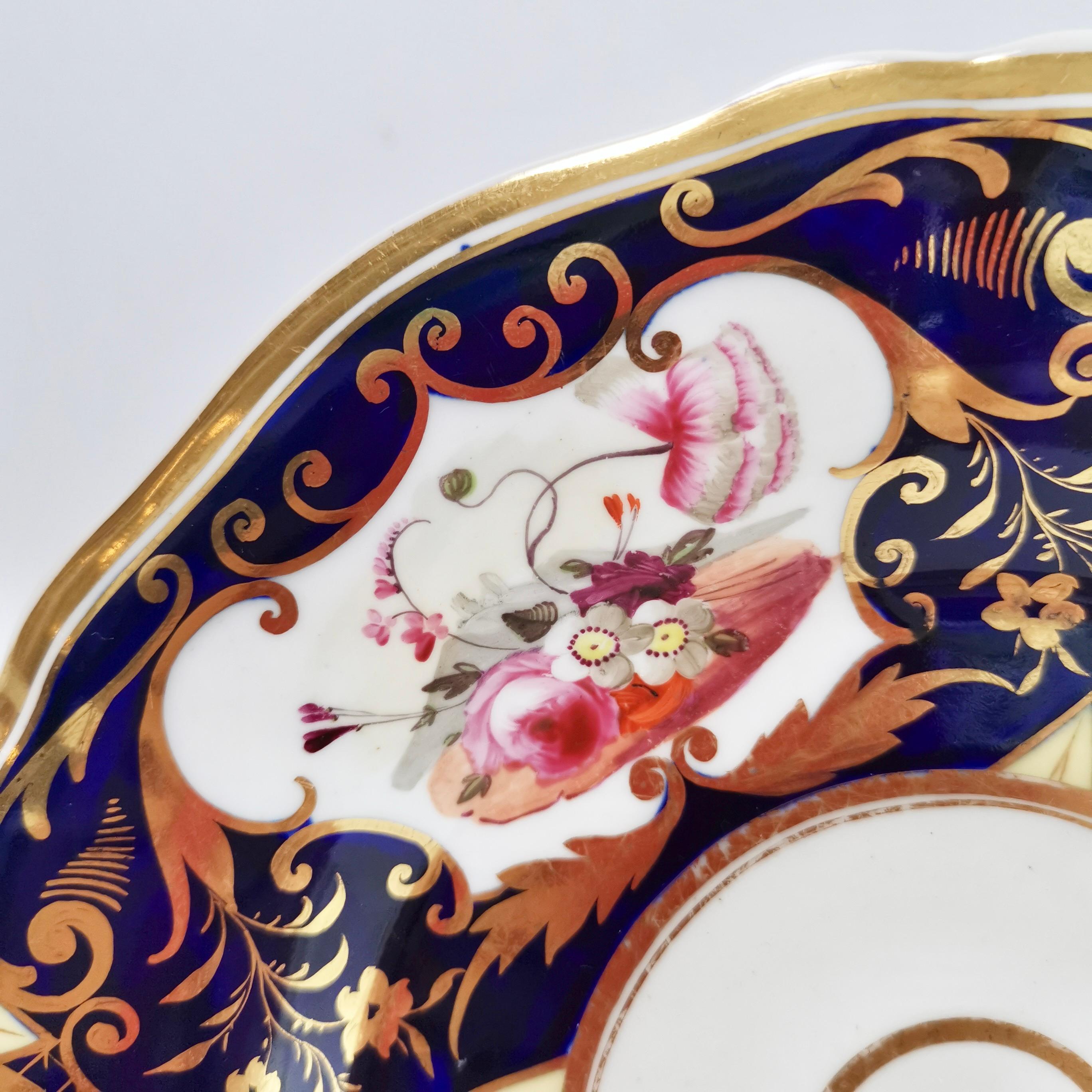 This is a beautiful plate made by Yates in about 1826, which is known as the Regency period. It is decorated with a striking pattern in cobalt blue, gilt and hand painted flowers.
 
I have two of these plates available, please see separate