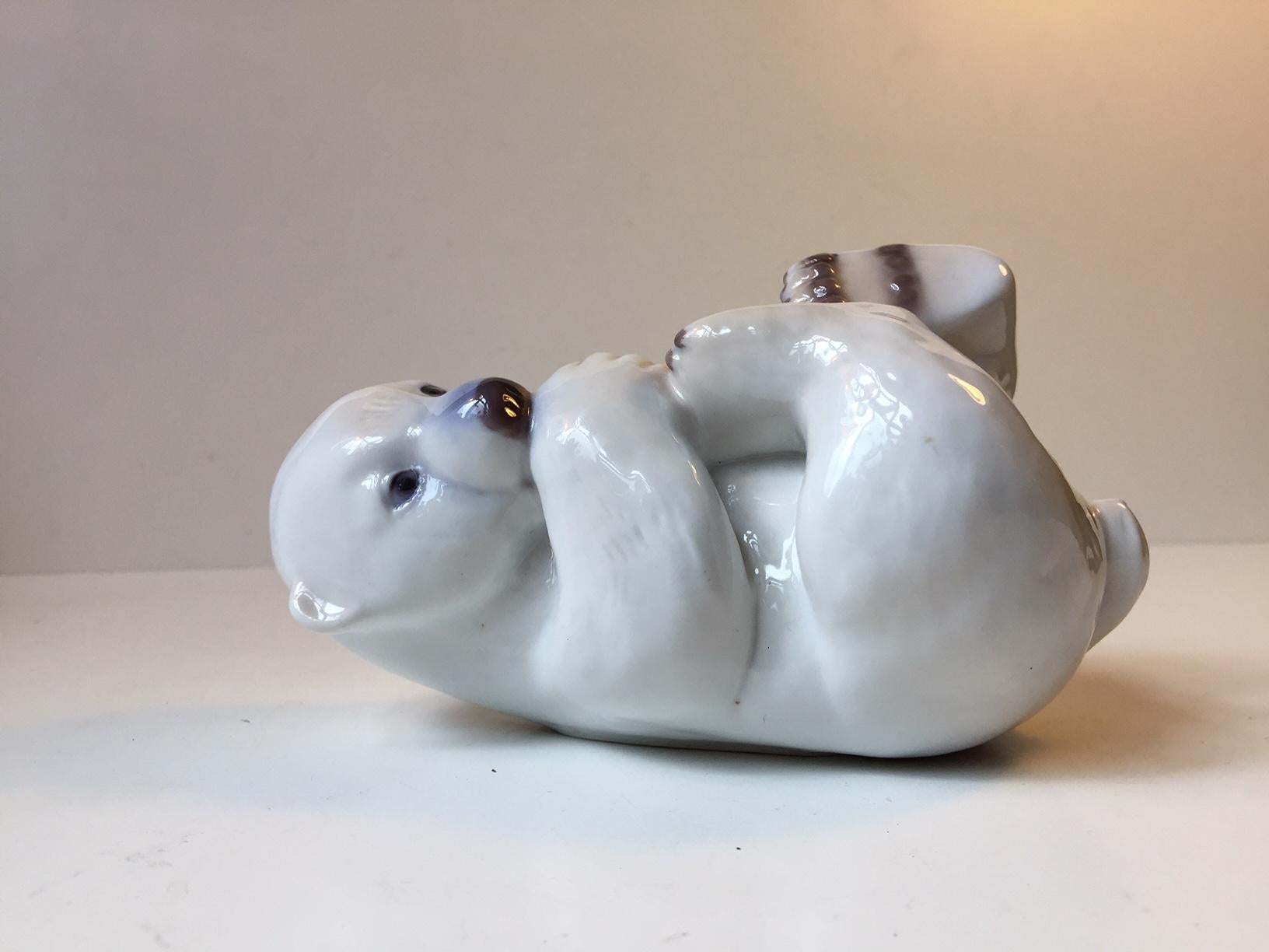 Hand decorated polar bear poppy in Porcelain. Designed by Merete Agergaard. Manufactured by B&G in Denmark during the 1970s. Design/model number: 2538. Meant to lie down on its back but can stand up as well. Fully marked and signed by the artist to