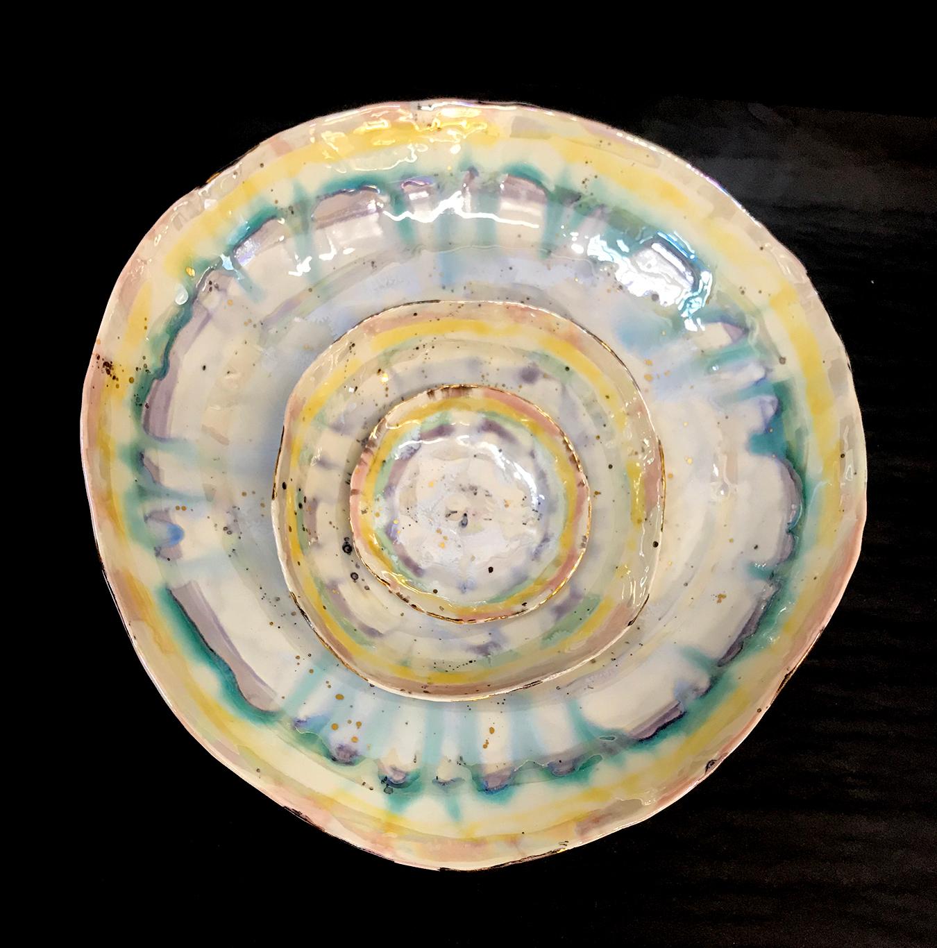 This set of three prism dishes by Minh Singer is hand-built in porcelain and intricately glazed with a rainbow of celadon glazes and 22-karat gold and mother-of-pearl lusters. Singer's mesmerizing glaze technique requires several firings.

Each