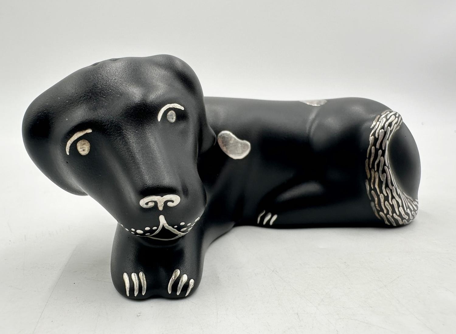 Vintage table sculptures made in porcelain and pure silver designed and manufactured in Mexico by Emilia Castillo.

The sculptures depict A dog and a cat made in porcelain with a black finish (dog) and white porcelain (cat) and pure silver
