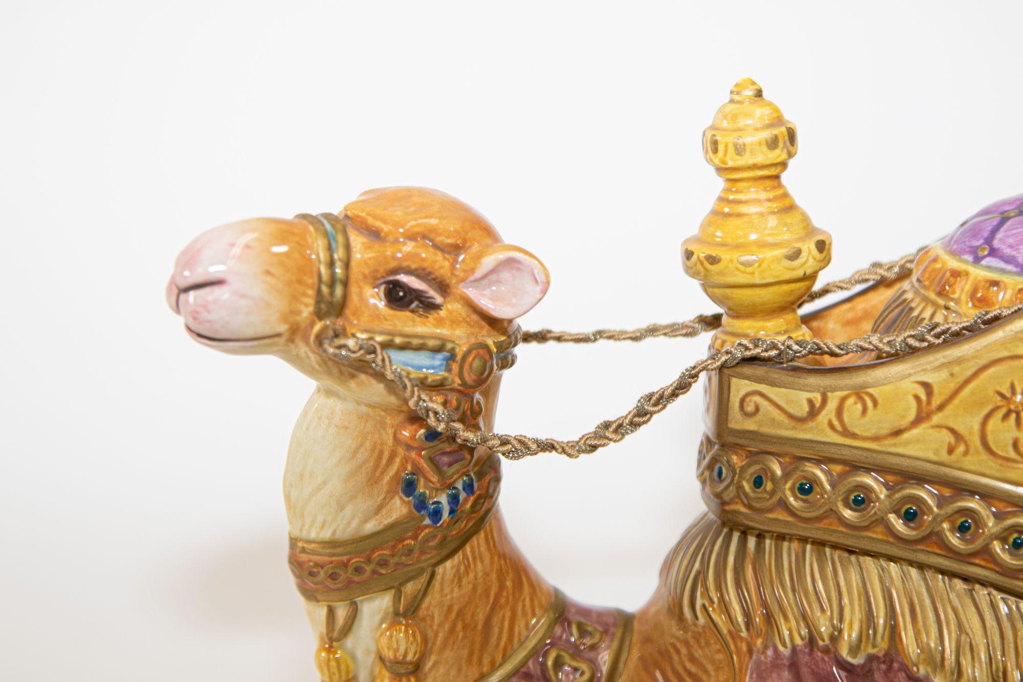Hand painted porcelain collectible Fitz and Floyd resting Nubian camel figurine.
Beautifully detailed Arabian camel, the camel is kneeling in rest and features a pastel hues and a saddle with golden accents.
Unique blend of artistry, tradition and