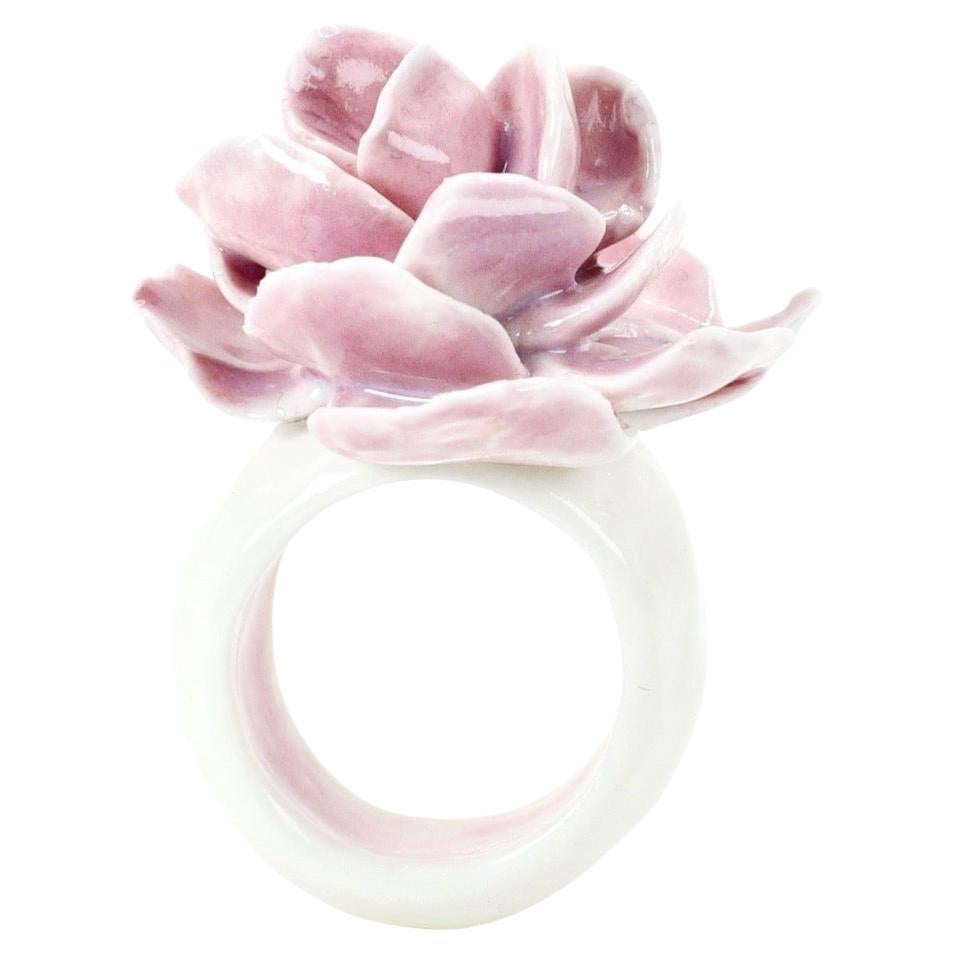 Porcelain  Handmade in London

Introducing our exquisite porcelain ring, a true work of art. This masterpiece features a meticulously hand-sculpted amethyst-colored rose, nestled within the band, crafted from the purest white porcelain. Each petal