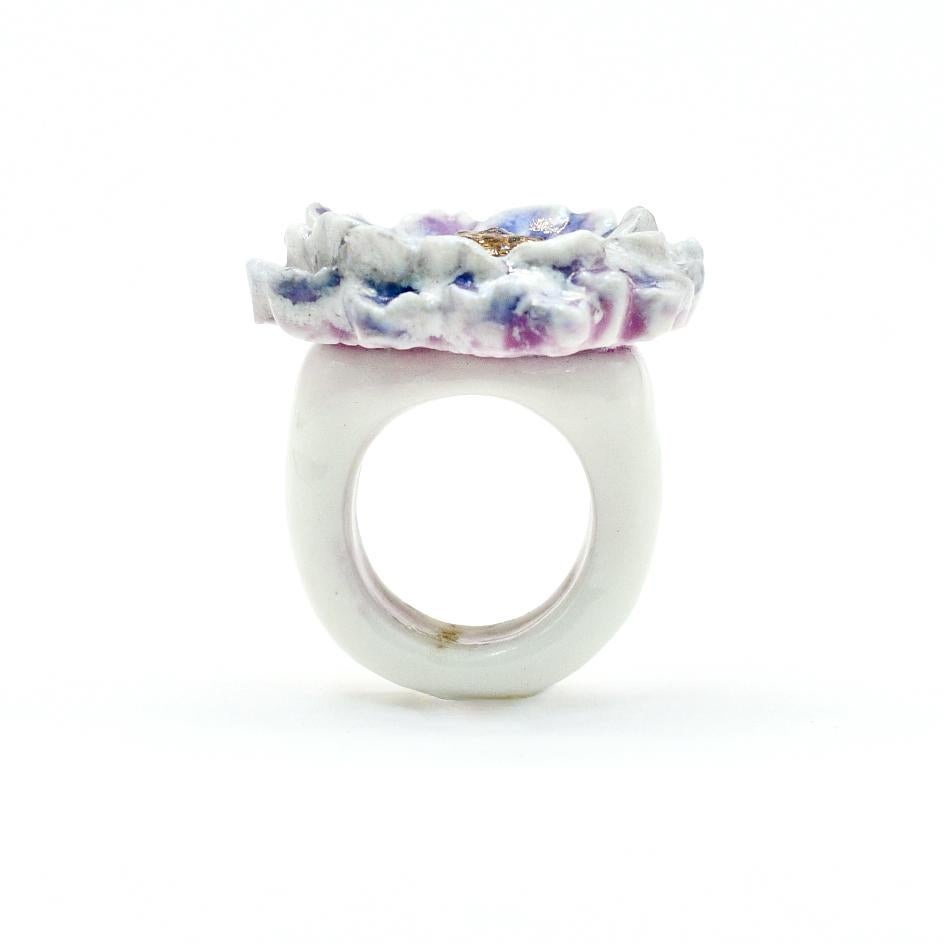 Porcelain  24K gold  Mother of Pearl Handmade in London 

Indulge in the luxurious elegance of the EVELINE Porcelain Ceramic Ring. Crafted from fine porcelain, this exquisite ring resembles a delicate dahlia flower. Its glimmering hues of purple and