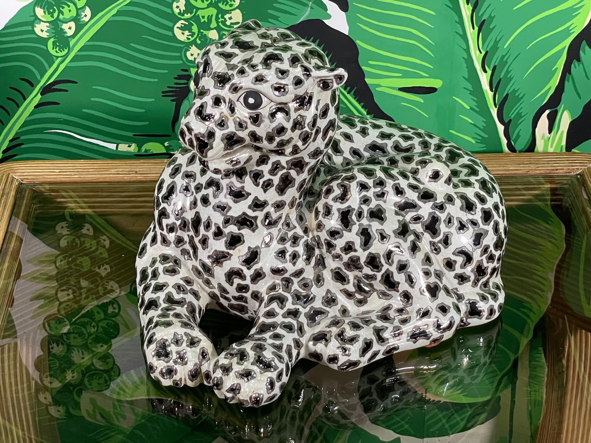 Pocelain leopard figurine features silver leaf accents and a glossy glazed finish. Marked 