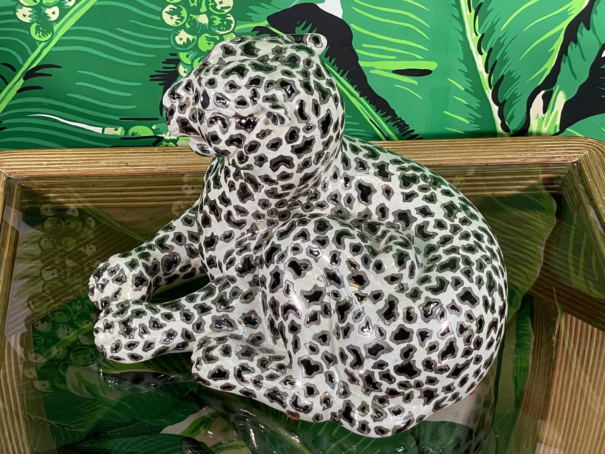 Porcelain leopard figurine features silver leaf accents and a glossy glazed finish. Marked 
