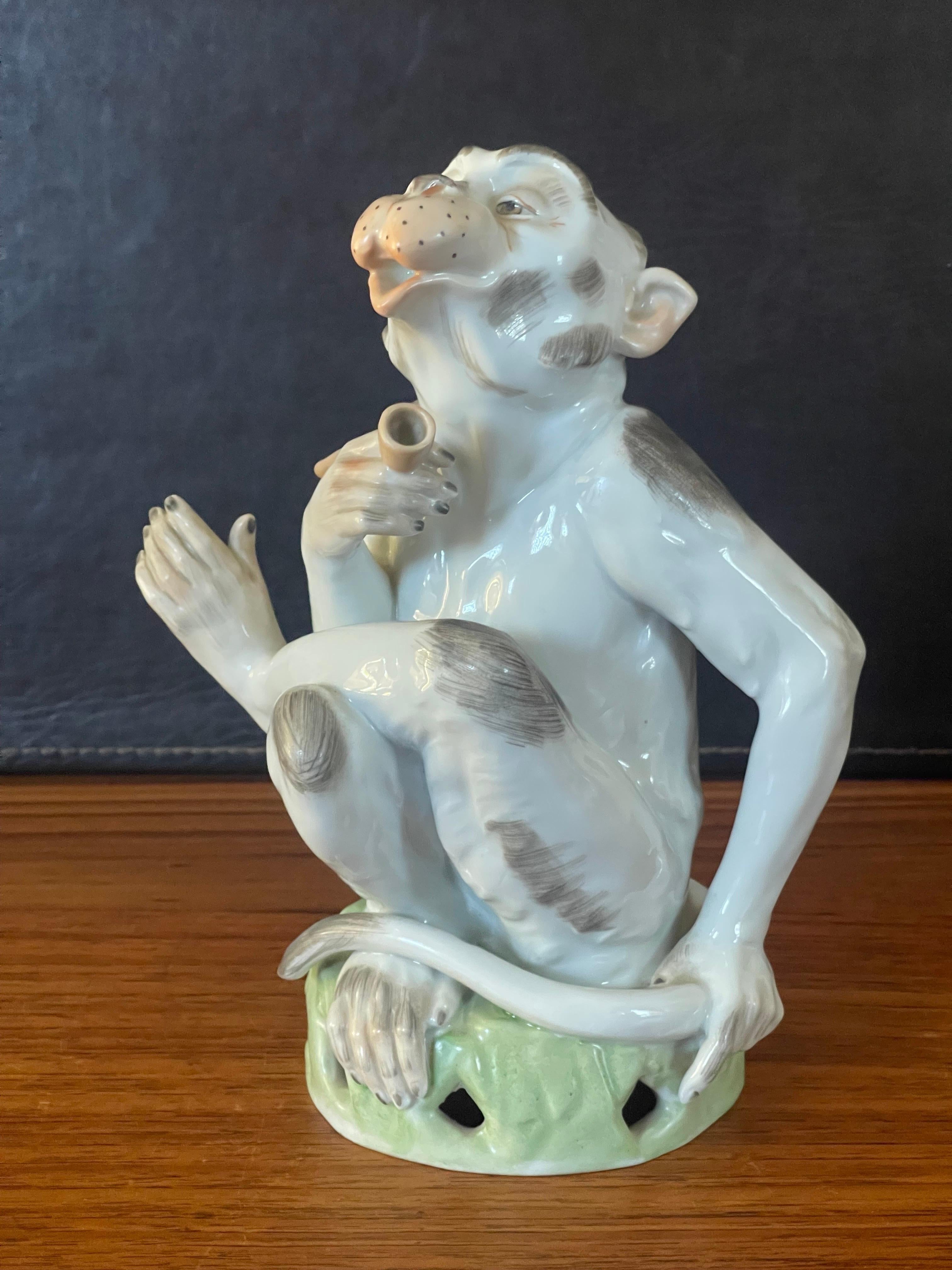 Whimsical porcelain smoking monkey with pipe by artist Carl Thieme for Dresden, circa 1920s. This finely formed porcelain figurine is entirely handmade and handpainted with stunning and refined colors. Handmade in Germany with blue Dresden marks on