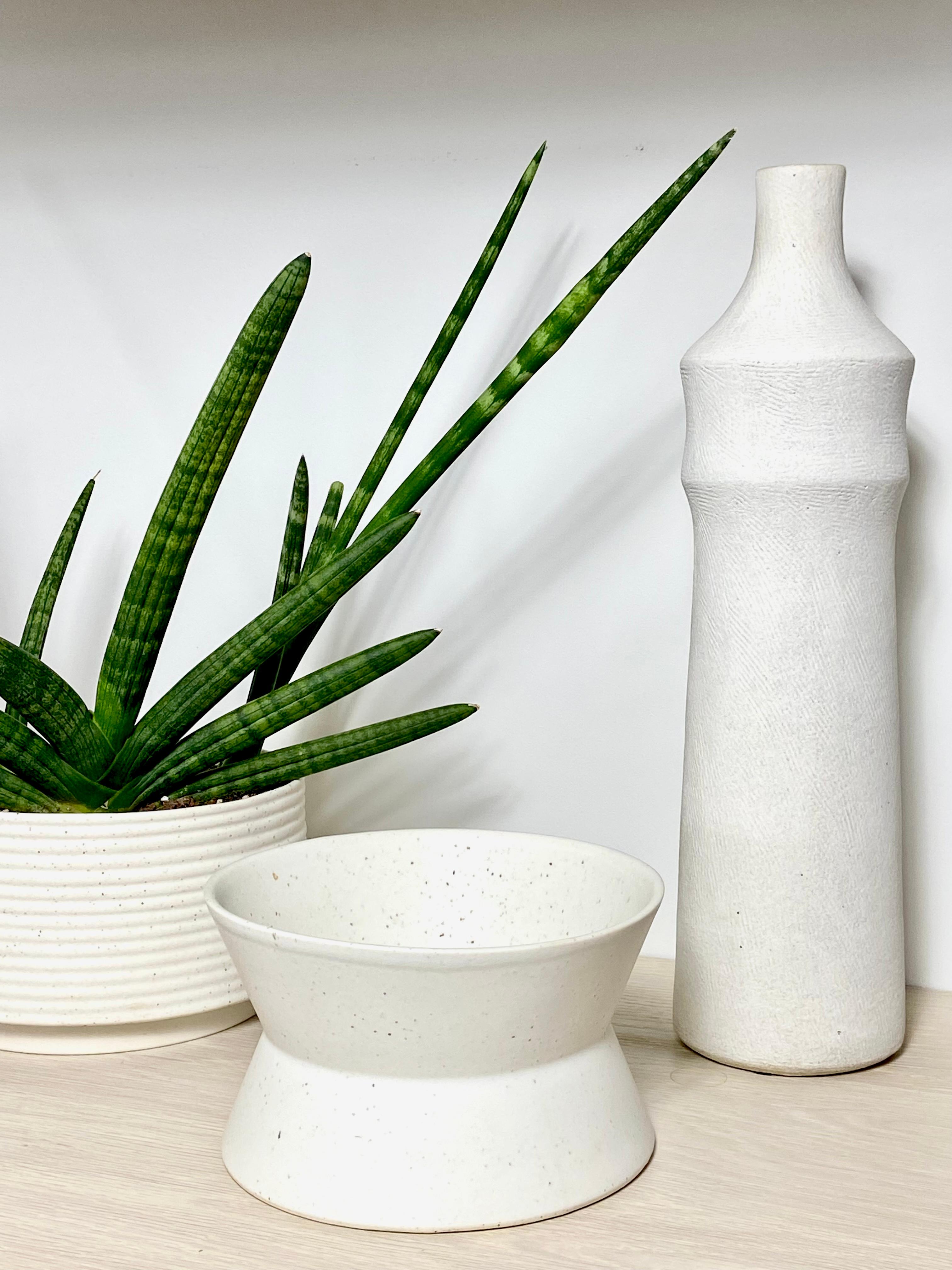 A speckled porcelain vase in a zig zag shape by Hudson Valley ceramic artist Andrew Molleur. It's an architectural form translated into a functional object. This hand-made bowl has a simple yet distinctive shape and is great for every day use,